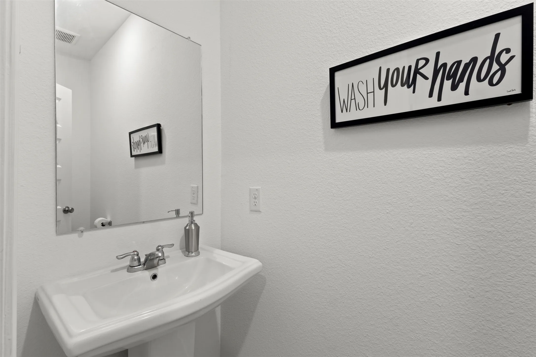 Half bathroom downstairs in office hallway