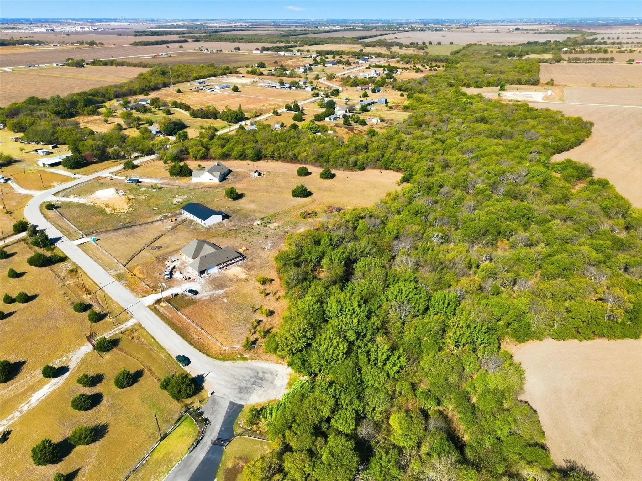 Expansive undeveloped lot featuring mature tree coverage, a cul-de-sac frontage, and a partially cleared area