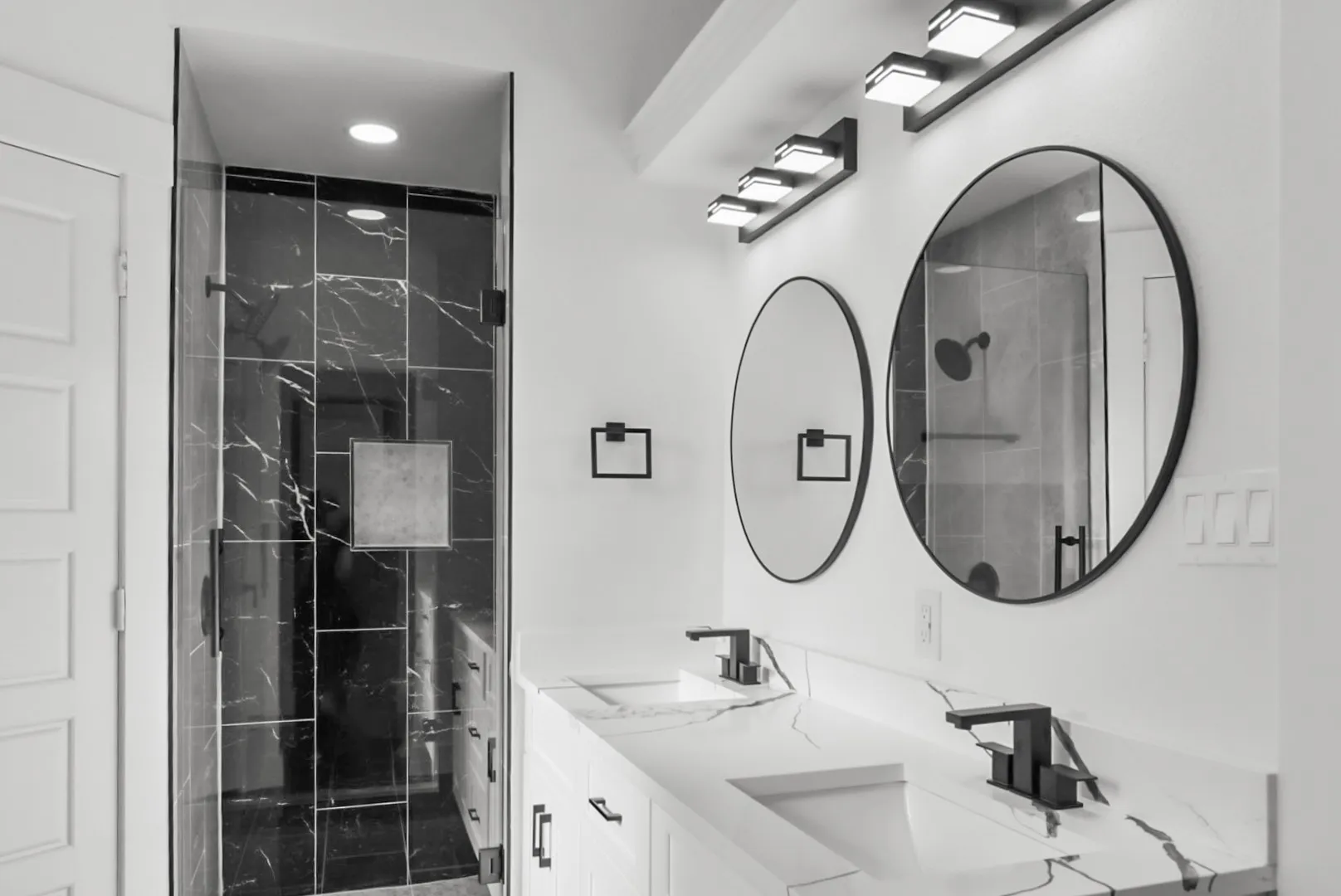Dual vanity featuring integrated sinks, white cabinetry, and a patterned countertop