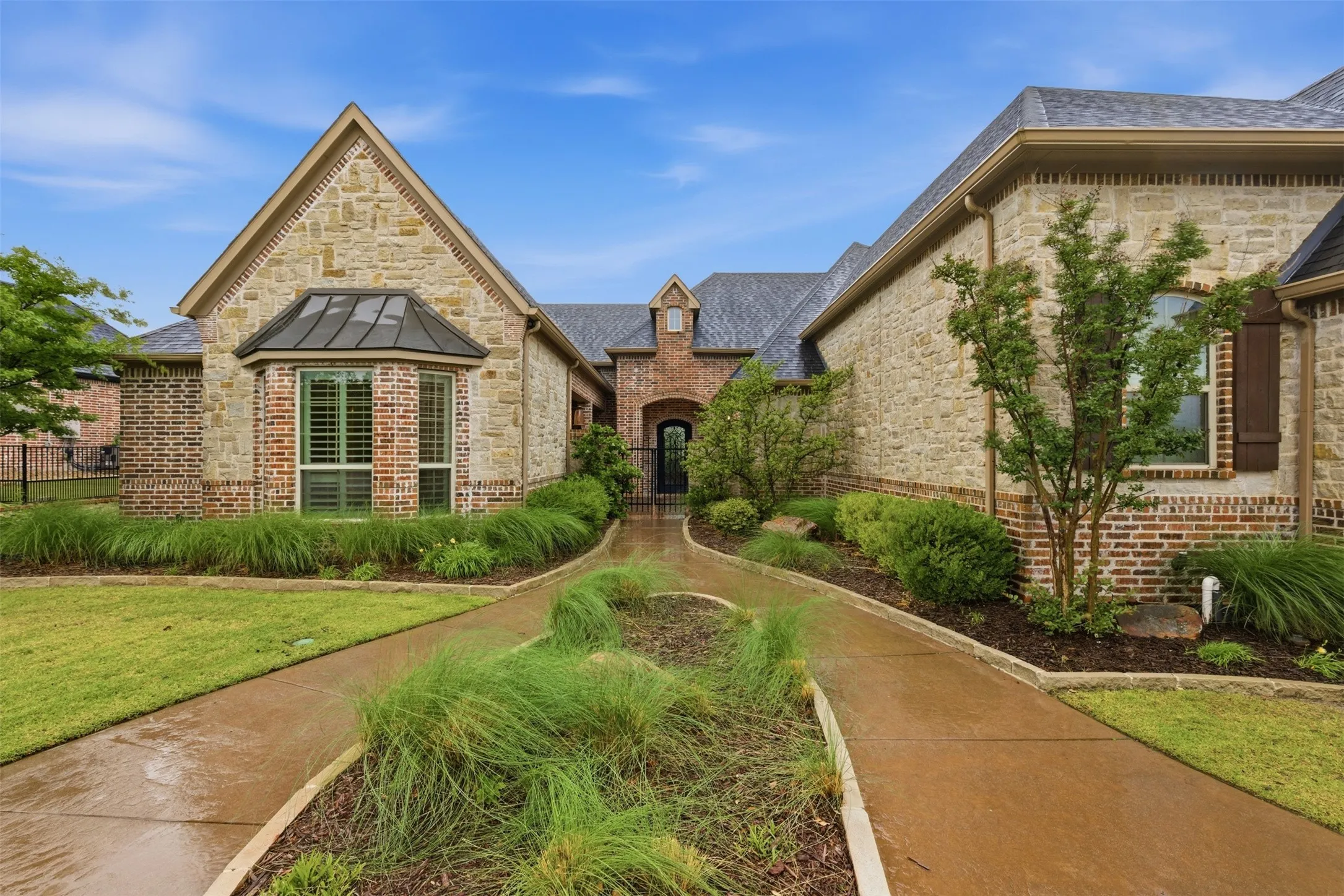 Stone and brick facade with dark shingle roofing