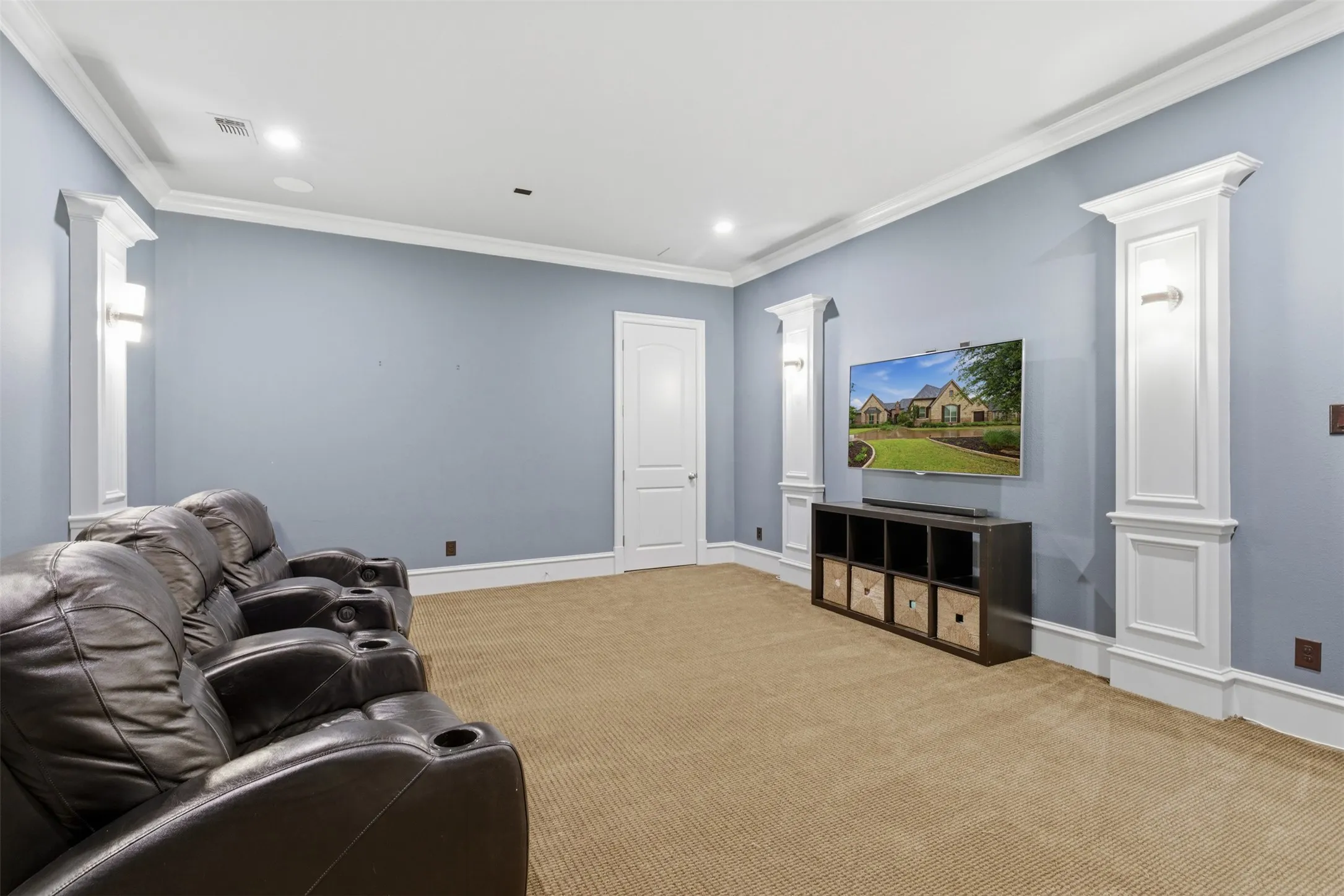 Carpeted room with crown molding and recessed lighting