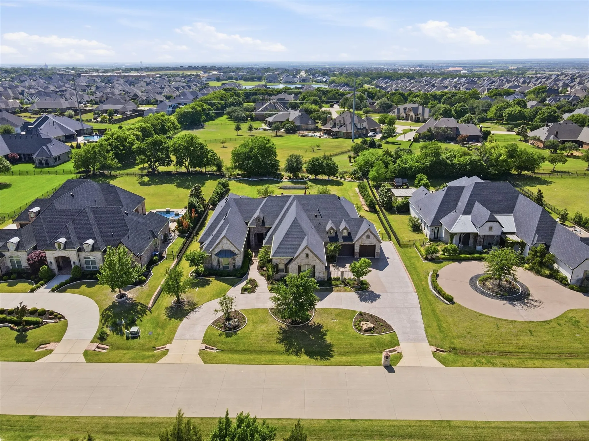 Expansive residential property featuring a stone and siding exterior with multiple gables