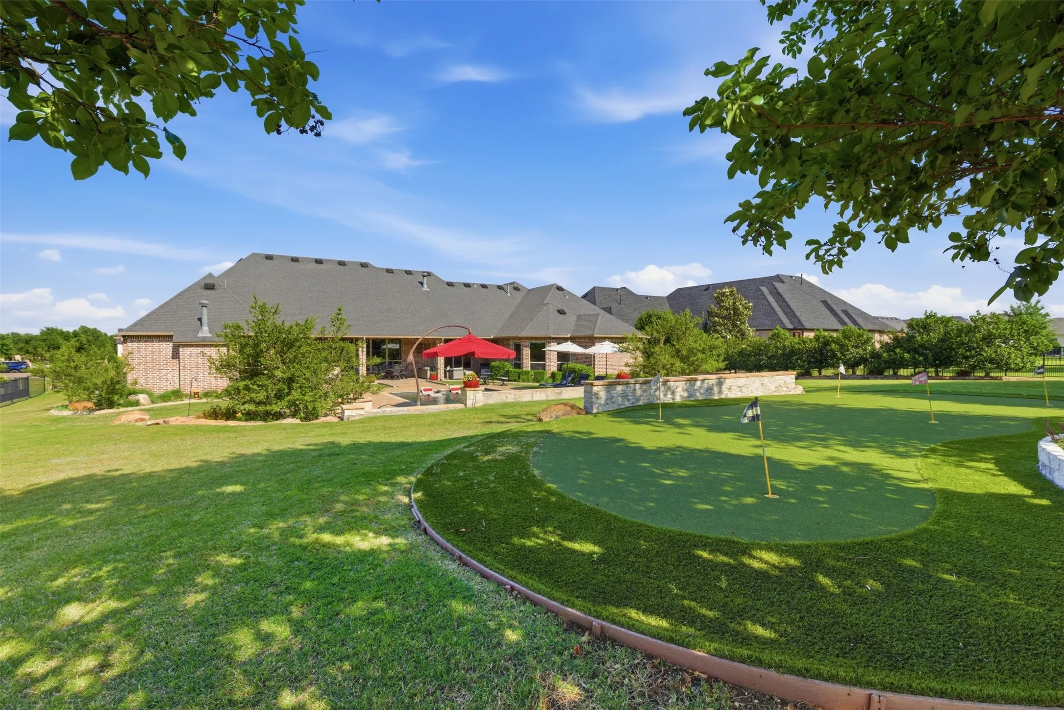 Expansive green lawn with a dedicated putting green