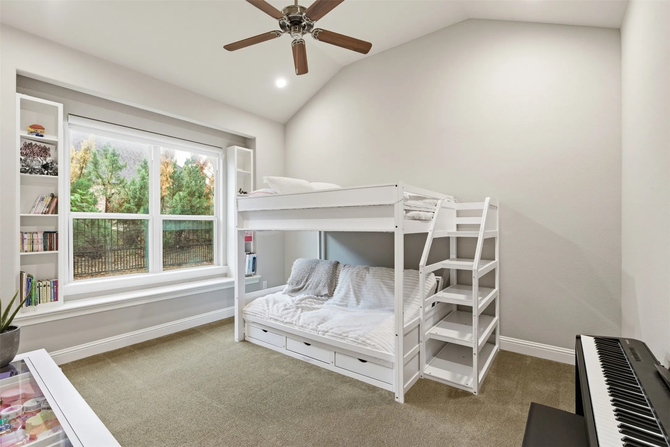 Spacious room featuring vaulted ceilings, recessed lighting, and light-toned carpet flooring