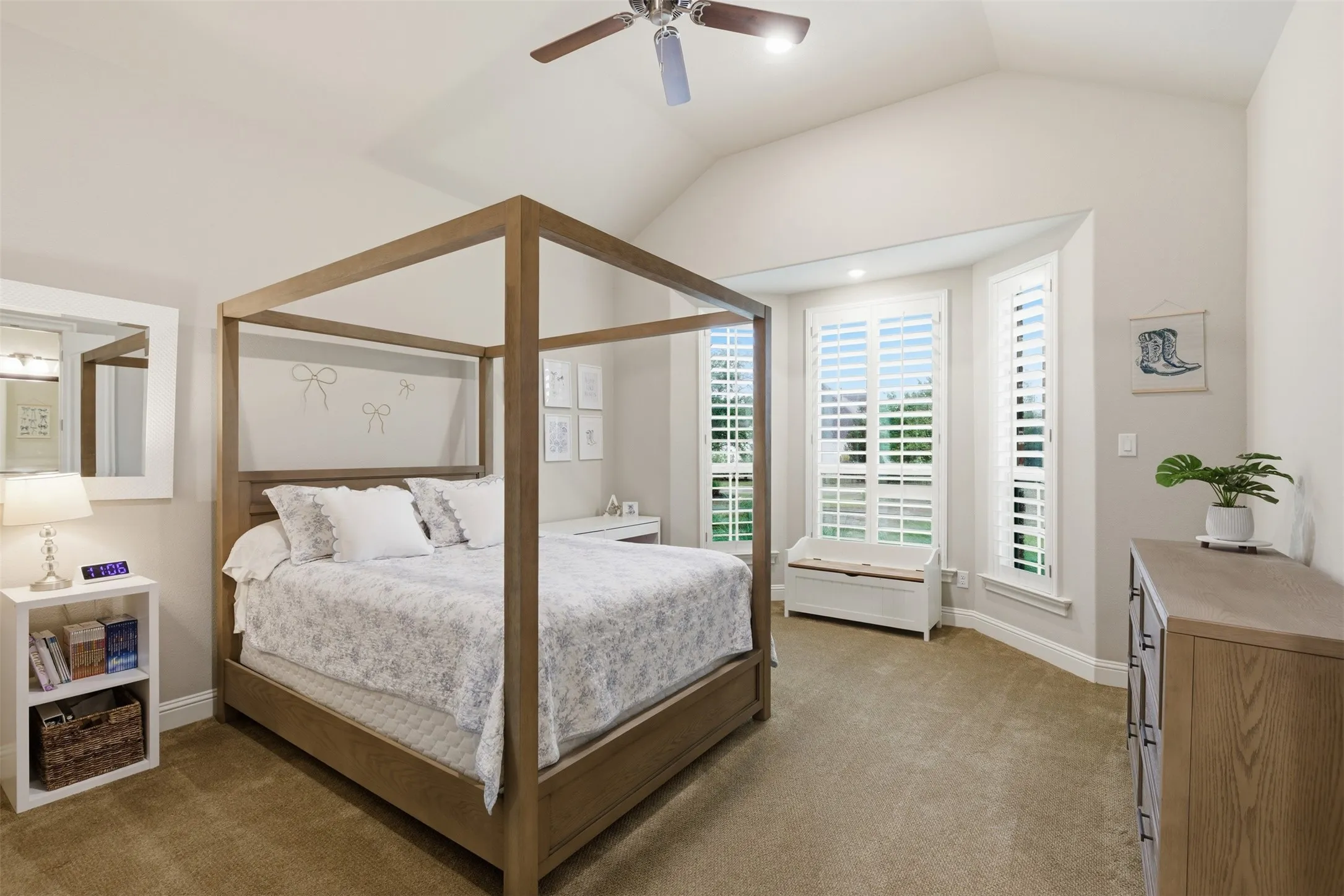 Spacious room featuring vaulted ceilings, a ceiling fan, and carpeted flooring