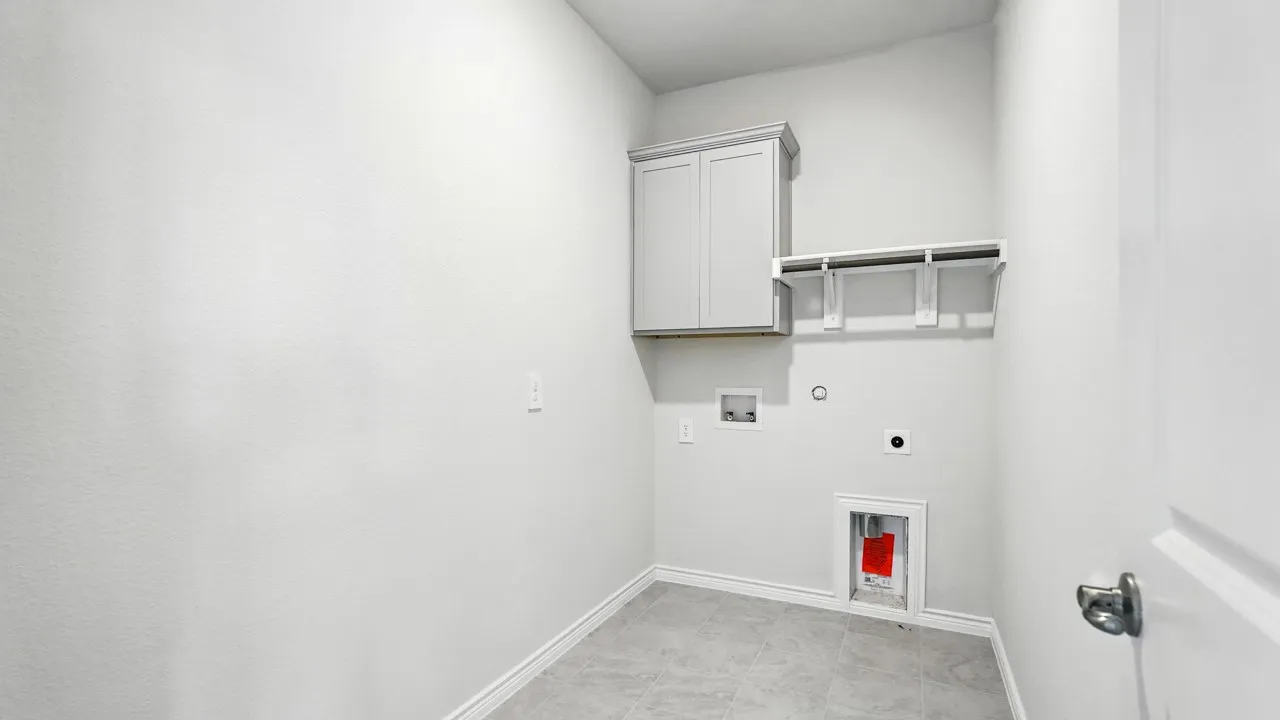 Utility room featuring gray wall cabinetry, open shelving, tile flooring, and light gray walls
