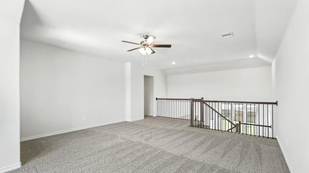 Spacious secondary living area featuring plush gray carpeting, a contemporary ceiling fan, and recessed lighting