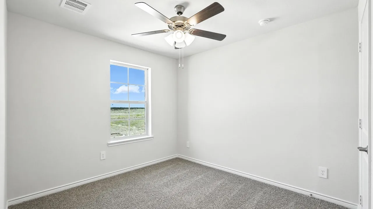 Room featuring light gray carpet, a window with a white frame, a ceiling fan with integrated lighting, and white walls