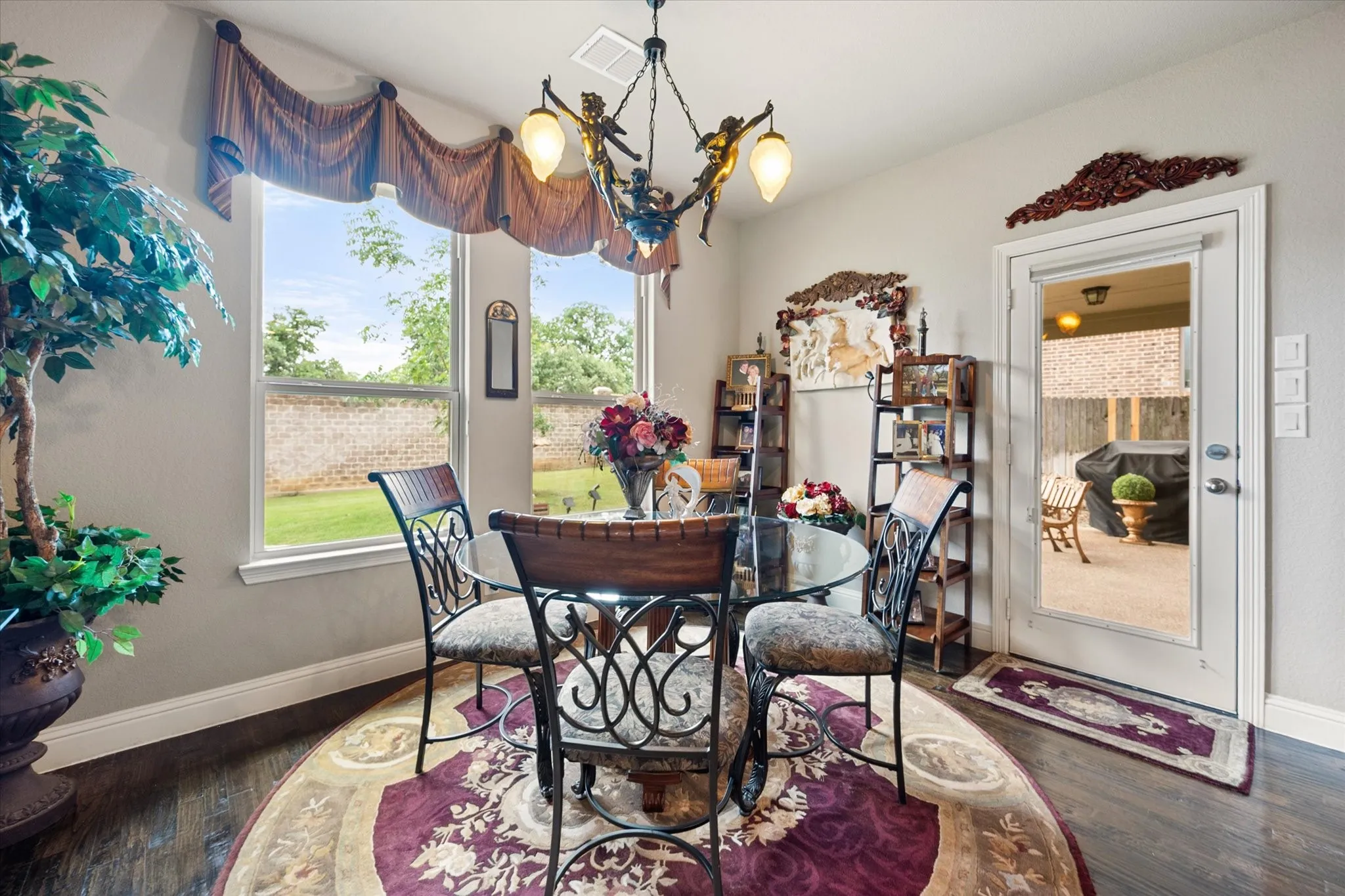 Breakfast area overlooking the private backyard and has access to the large covered back patio.