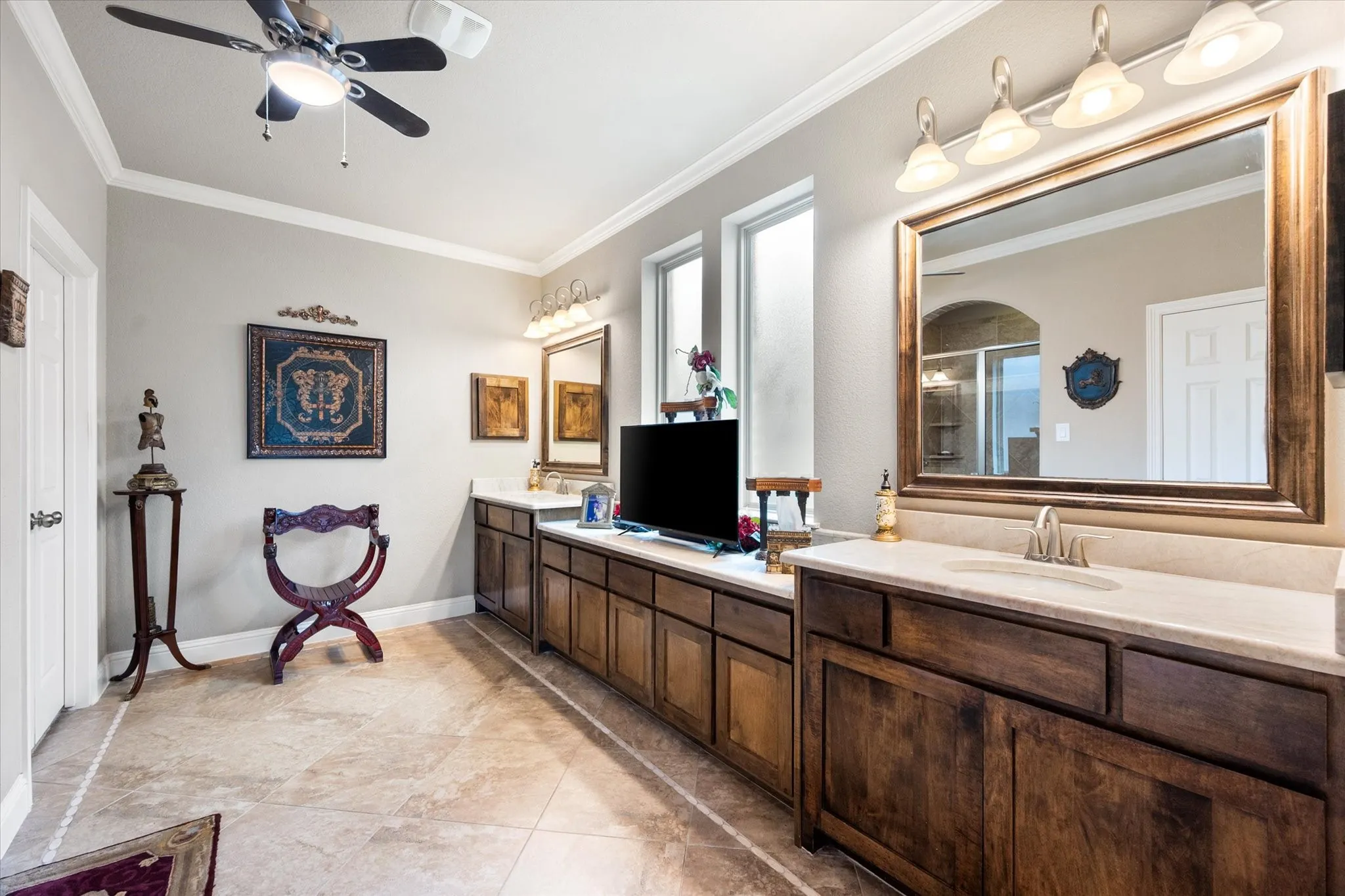 Massive primary bathroom has a ton of cabinets and counter space.  The current owners removed the garden tub and replaced with more taj mahal quartzite countertops.