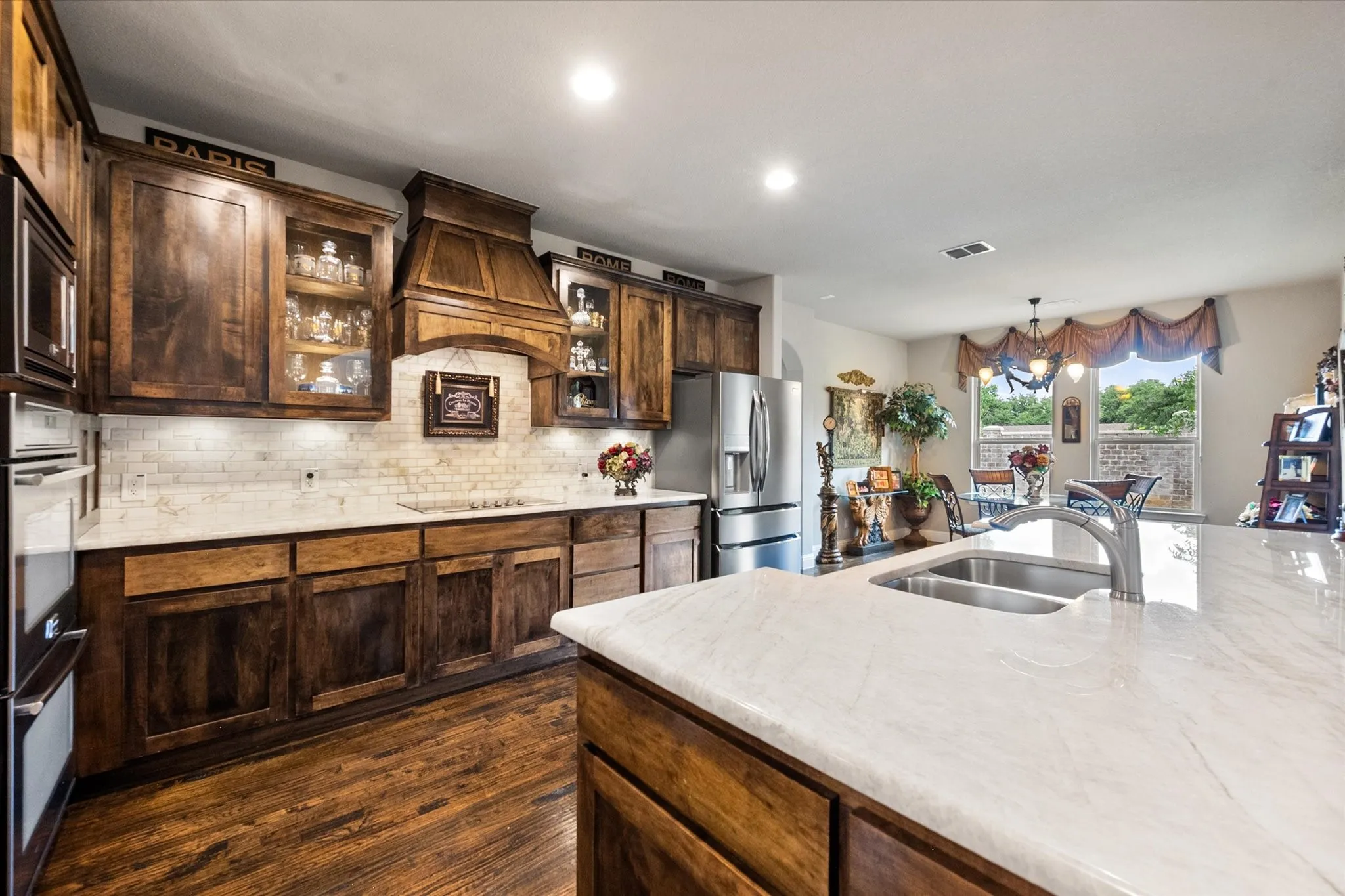 Massive center island, gorgeous Taj Mahal quartzite countertops, double ovens, a custom wood canopy vent hood and upgraded backsplash are the many features you will love in this kitchen!