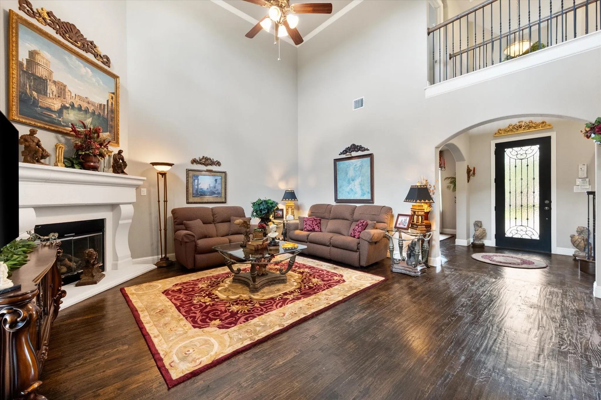 Handscraped hardwood floors in the living room, soaring ceilings, gas fireplace