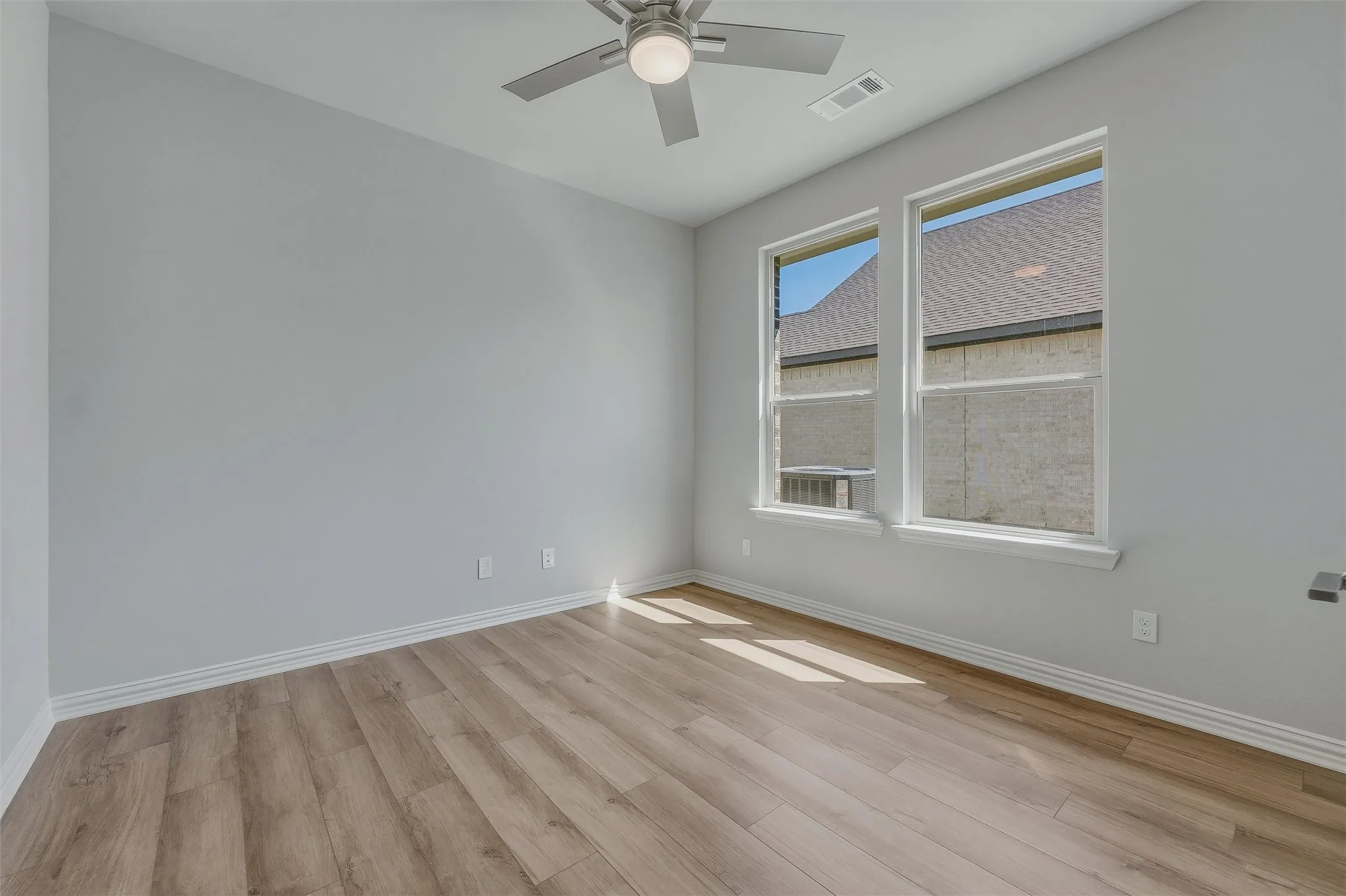 Light wood-finish flooring complemented by light-toned walls