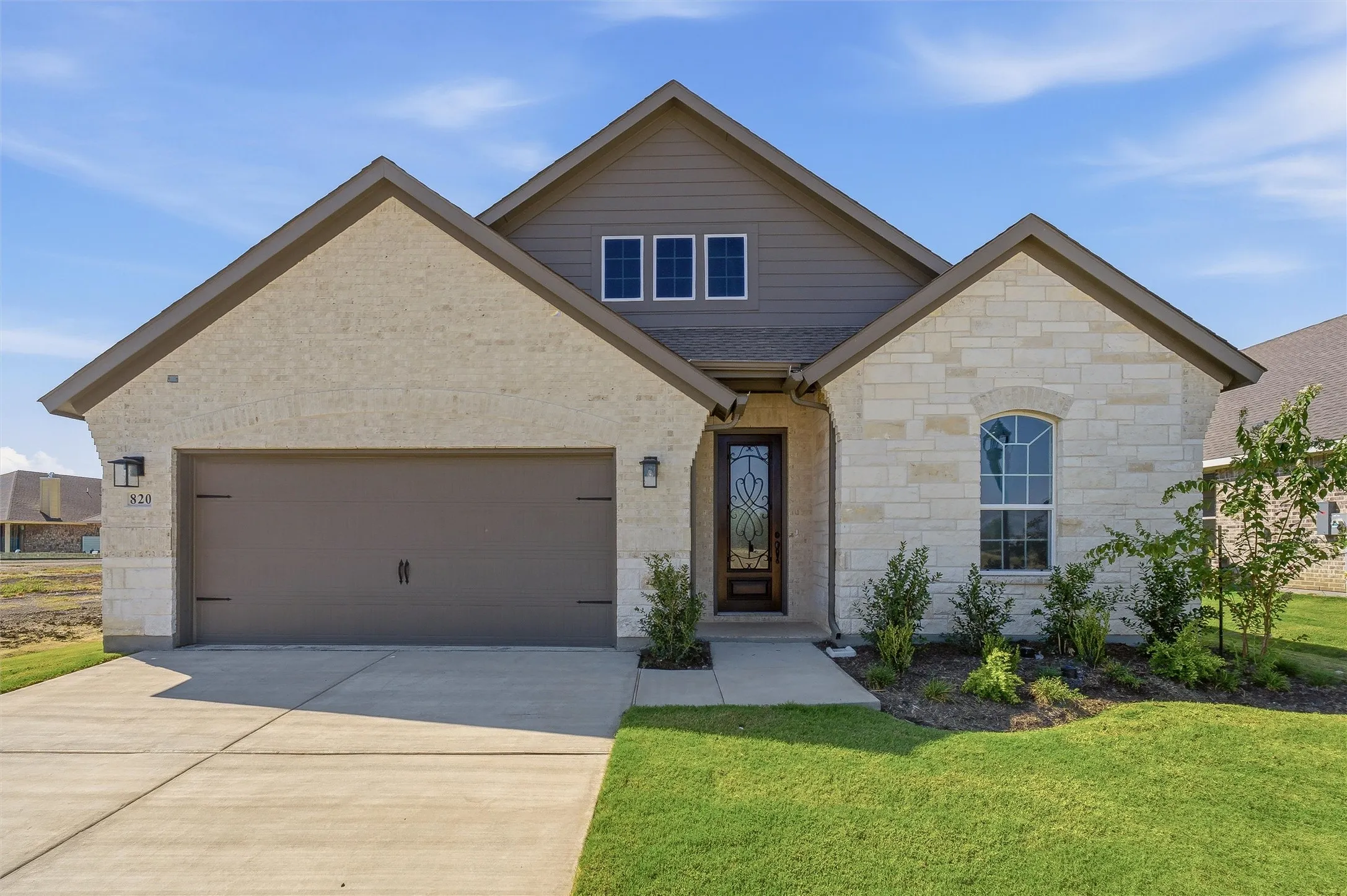 Stone and siding exterior with a gabled roof
