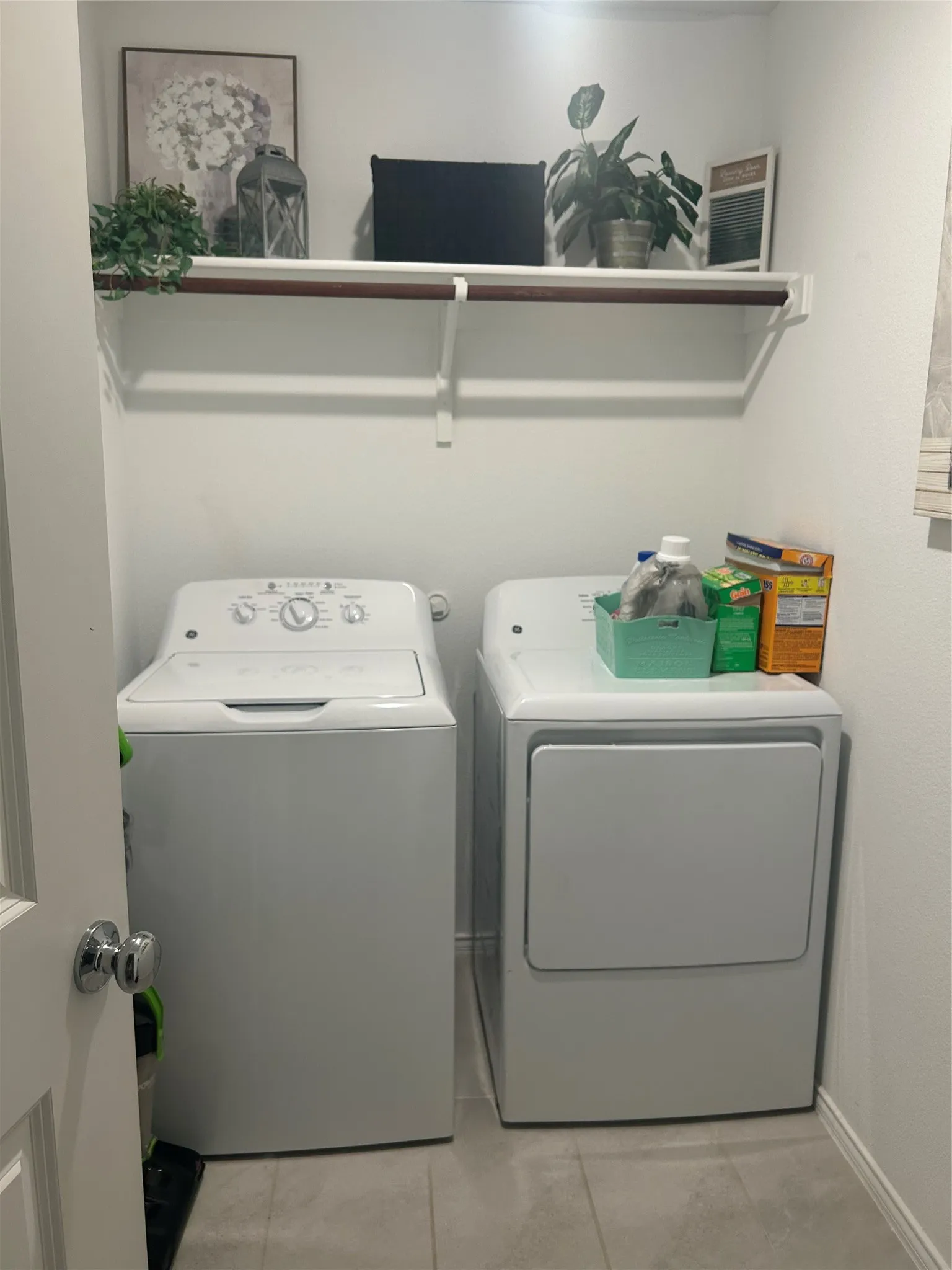 Dedicated laundry area featuring a white top-load washing machine and a white dryer