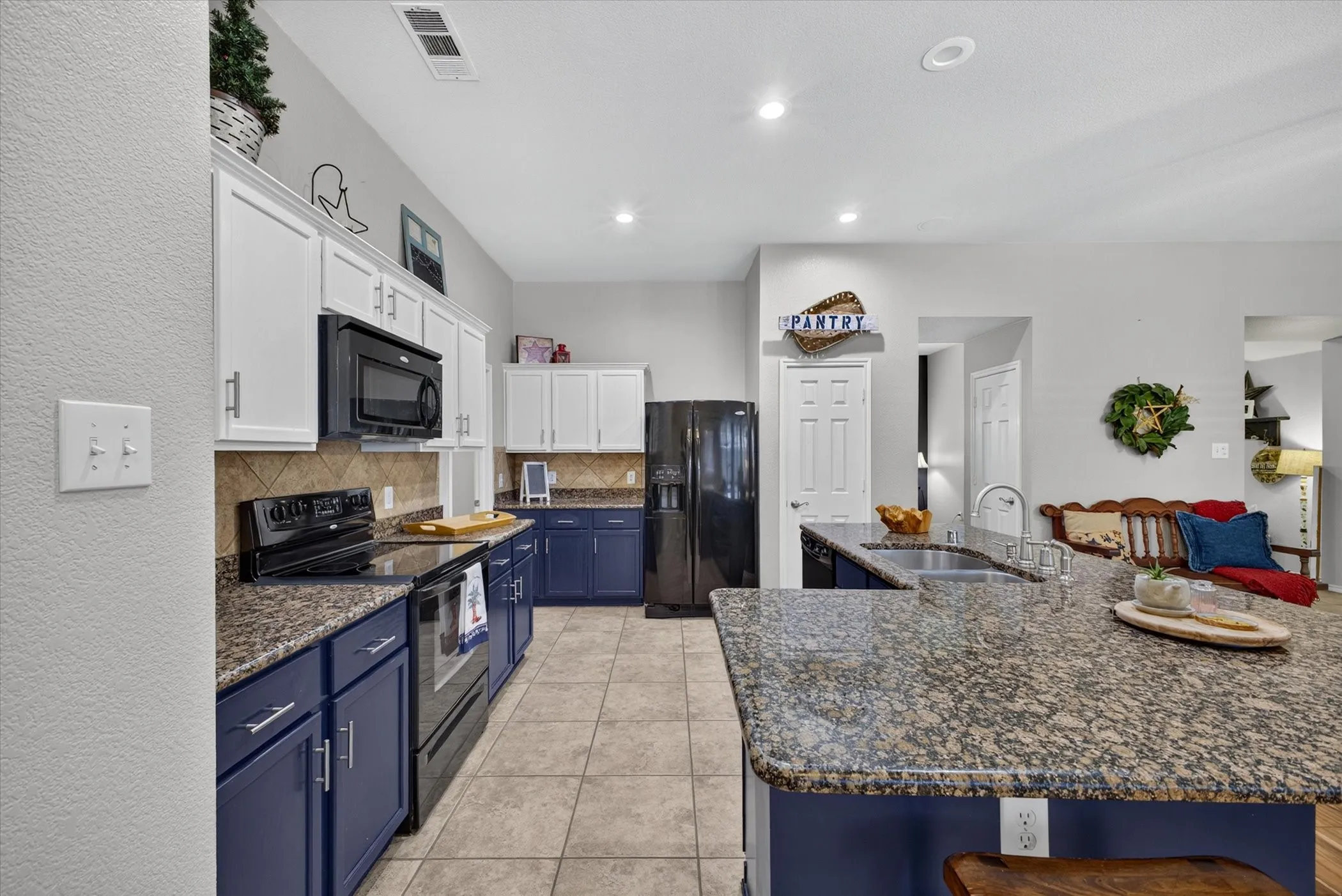 Spacious kitchen with granite, tile floors and open to living area