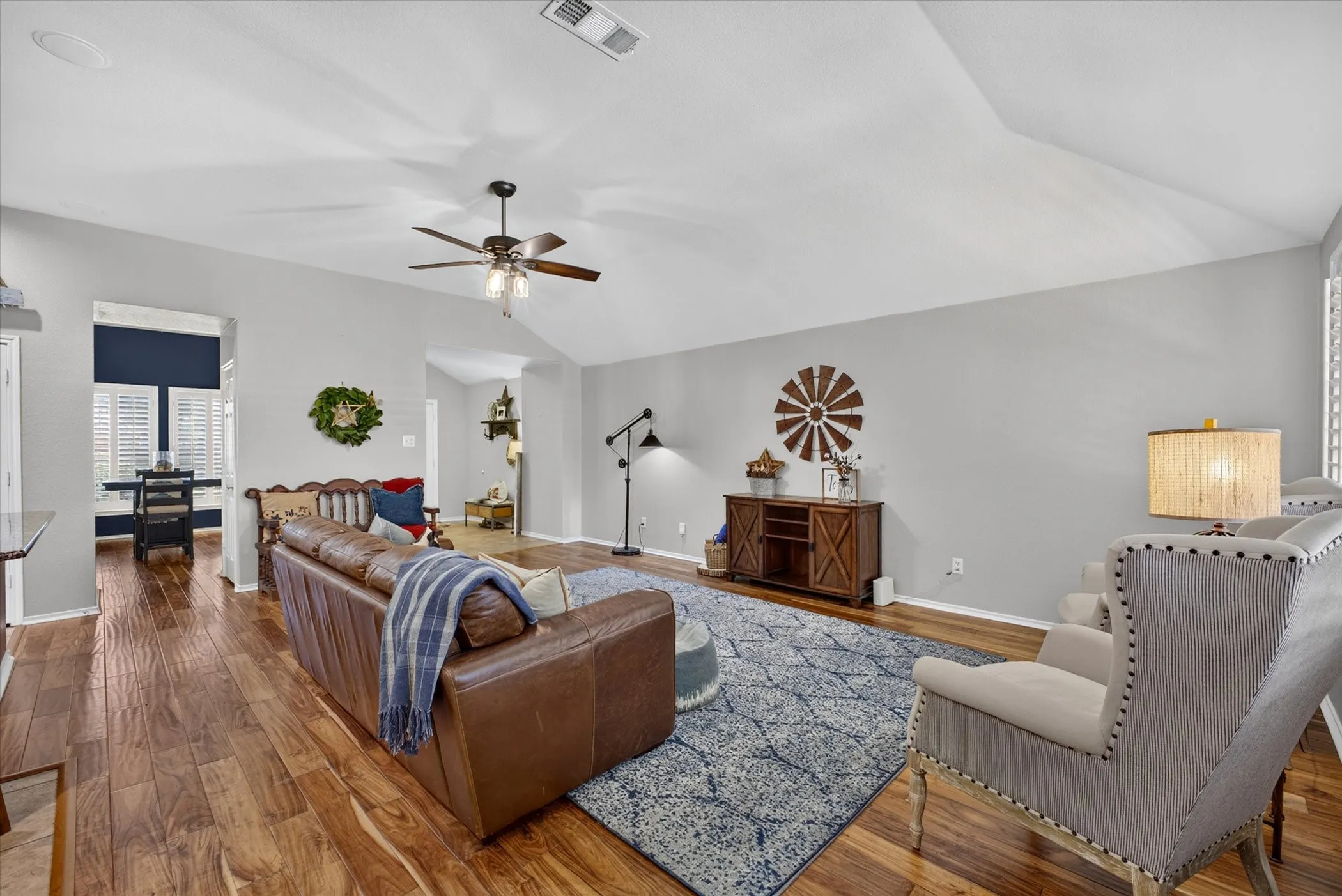 Large room with engineered hardwood floor. Open to kitchen