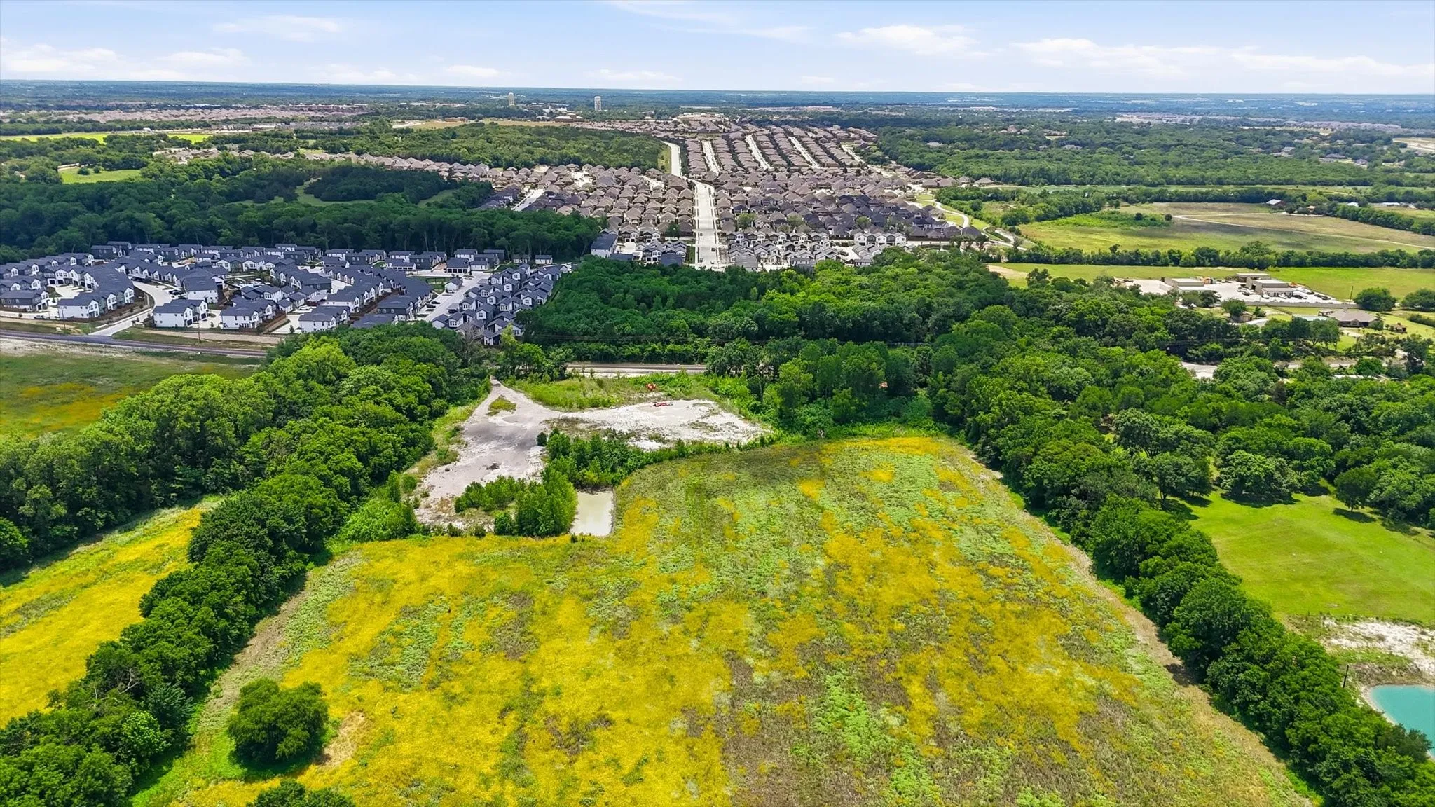 Expansive undeveloped land featuring natural foliage and a partial water body