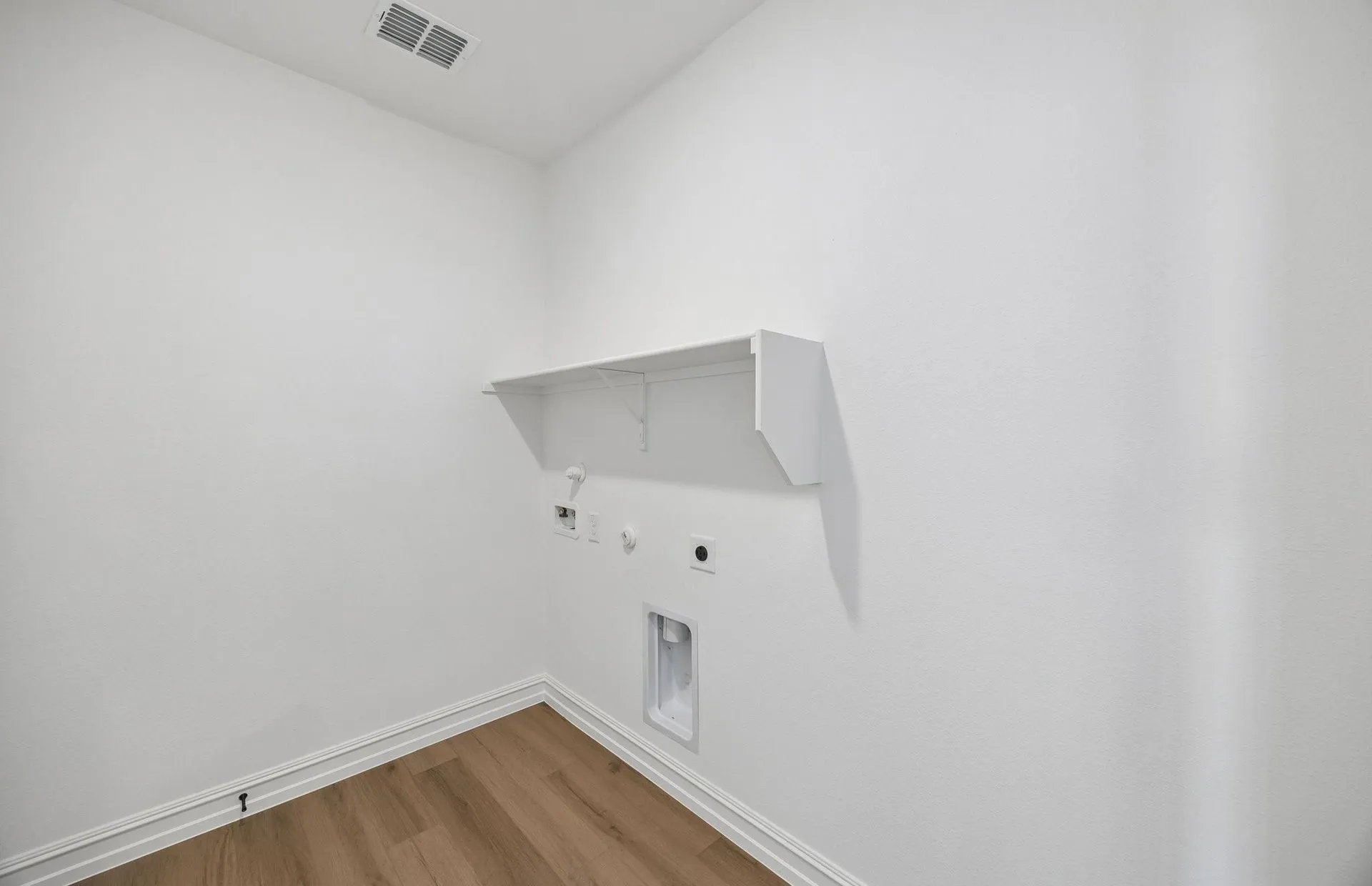 Laundry room with built-in shelving
