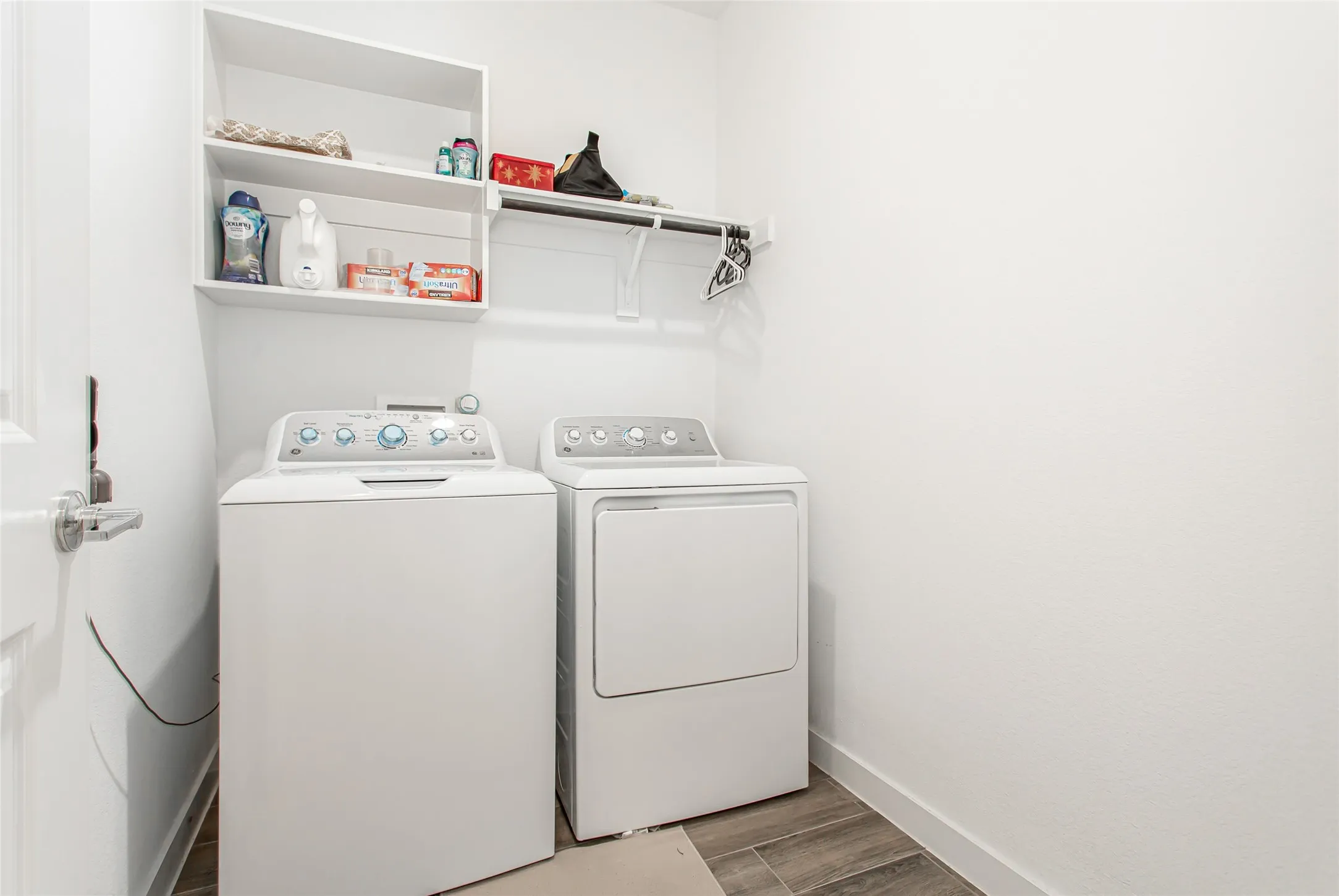 Dedicated laundry area featuring a top-loading washing machine and a front-loading dryer