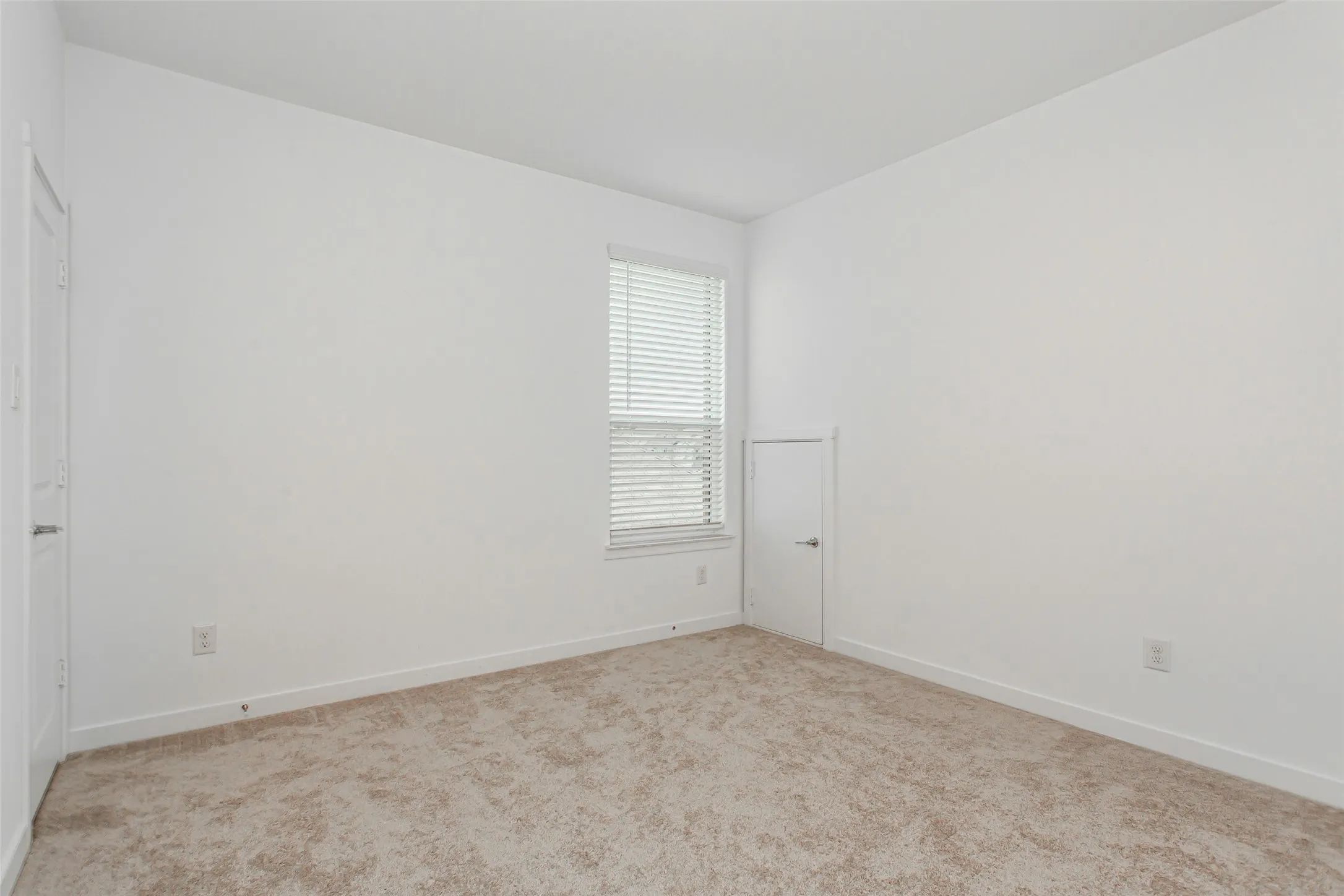 2nd floor bedroom 2 with Jack and Jill bath. Private sink area. Neutral-toned carpeting and white walls define this interior space