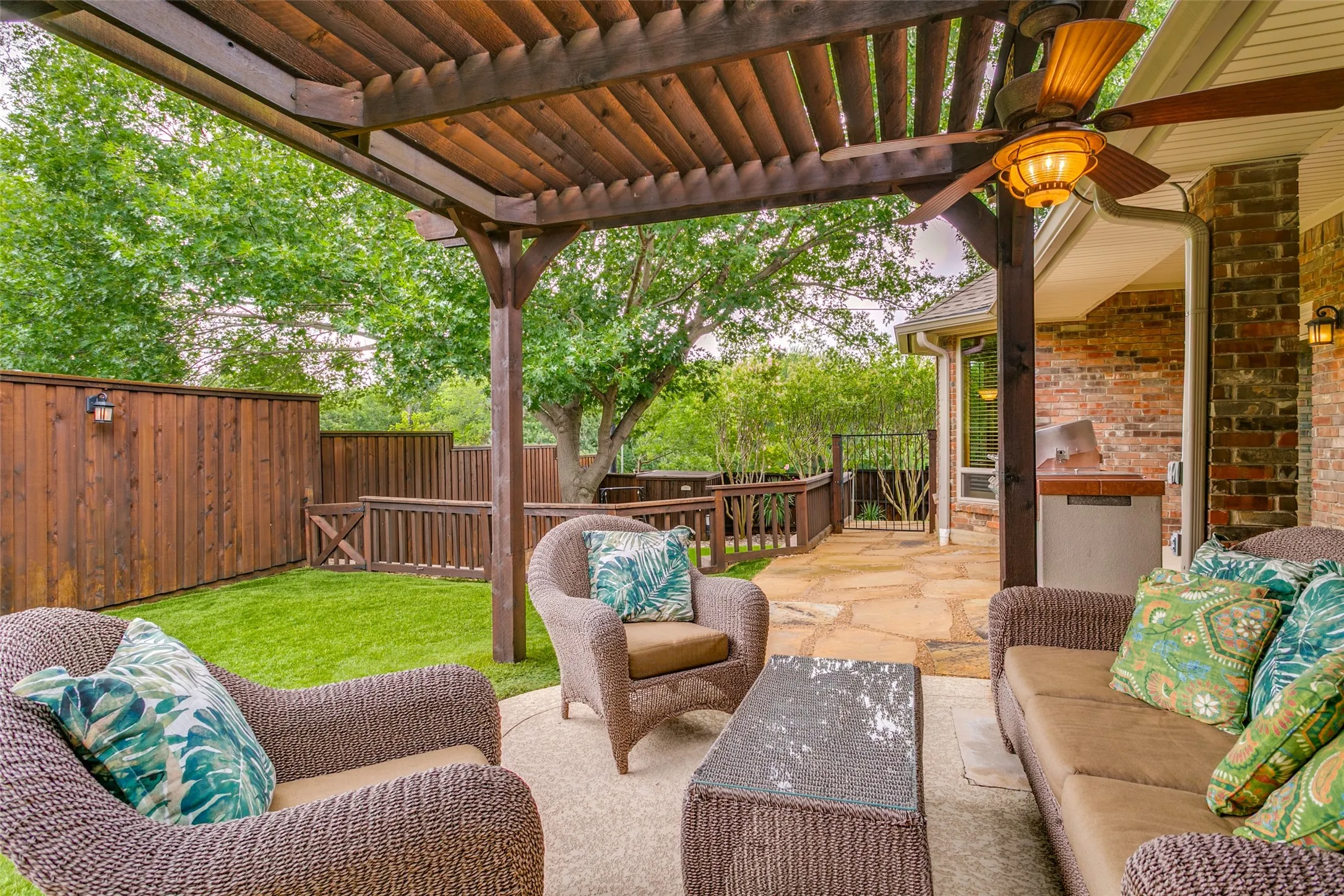 Relax year-round beneath the covered patio overlooking the beautifully landscaped backyard