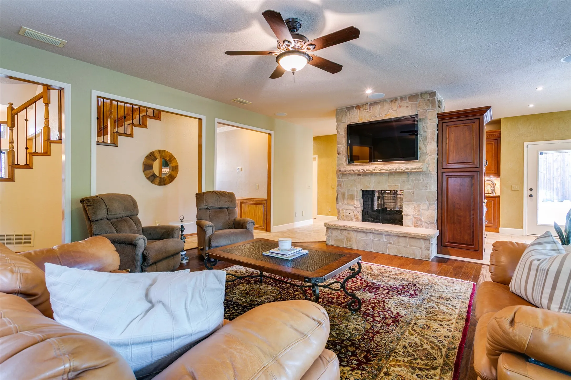 A stunning double-sided fireplace connects the living room and kitchen