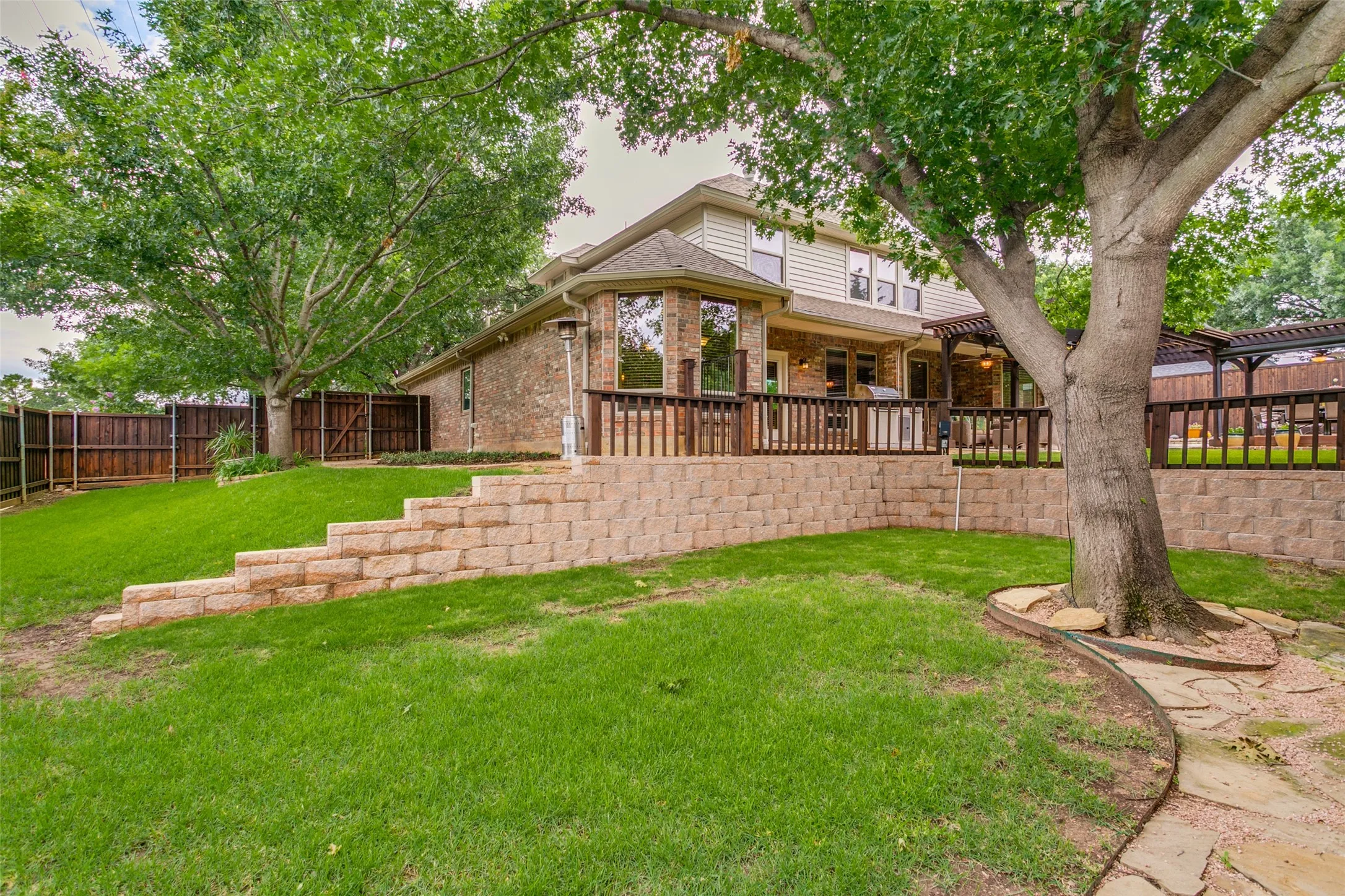 Rare .346-acre homesite offers mature shade trees, terraced landscaping, and abundant yard space