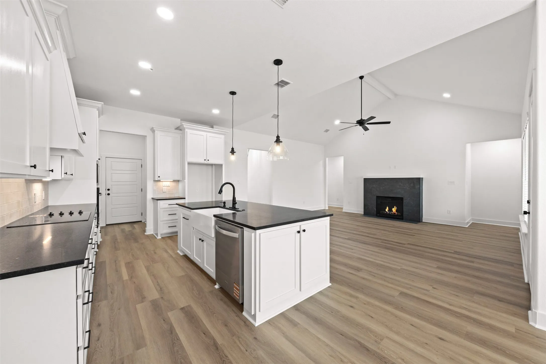 Open-concept kitchen and living area featuring wood-finish flooring