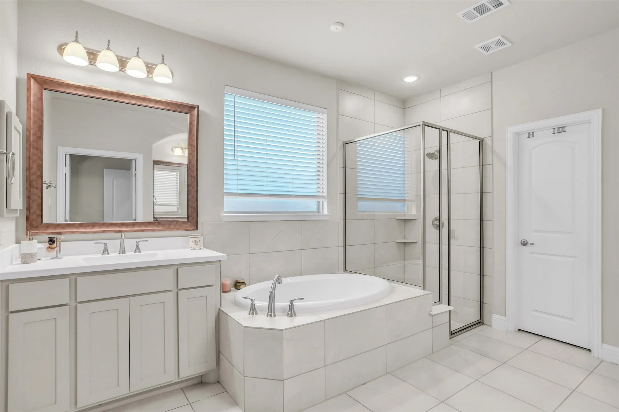 Dual vanities, soaking tub and separate tiled shower