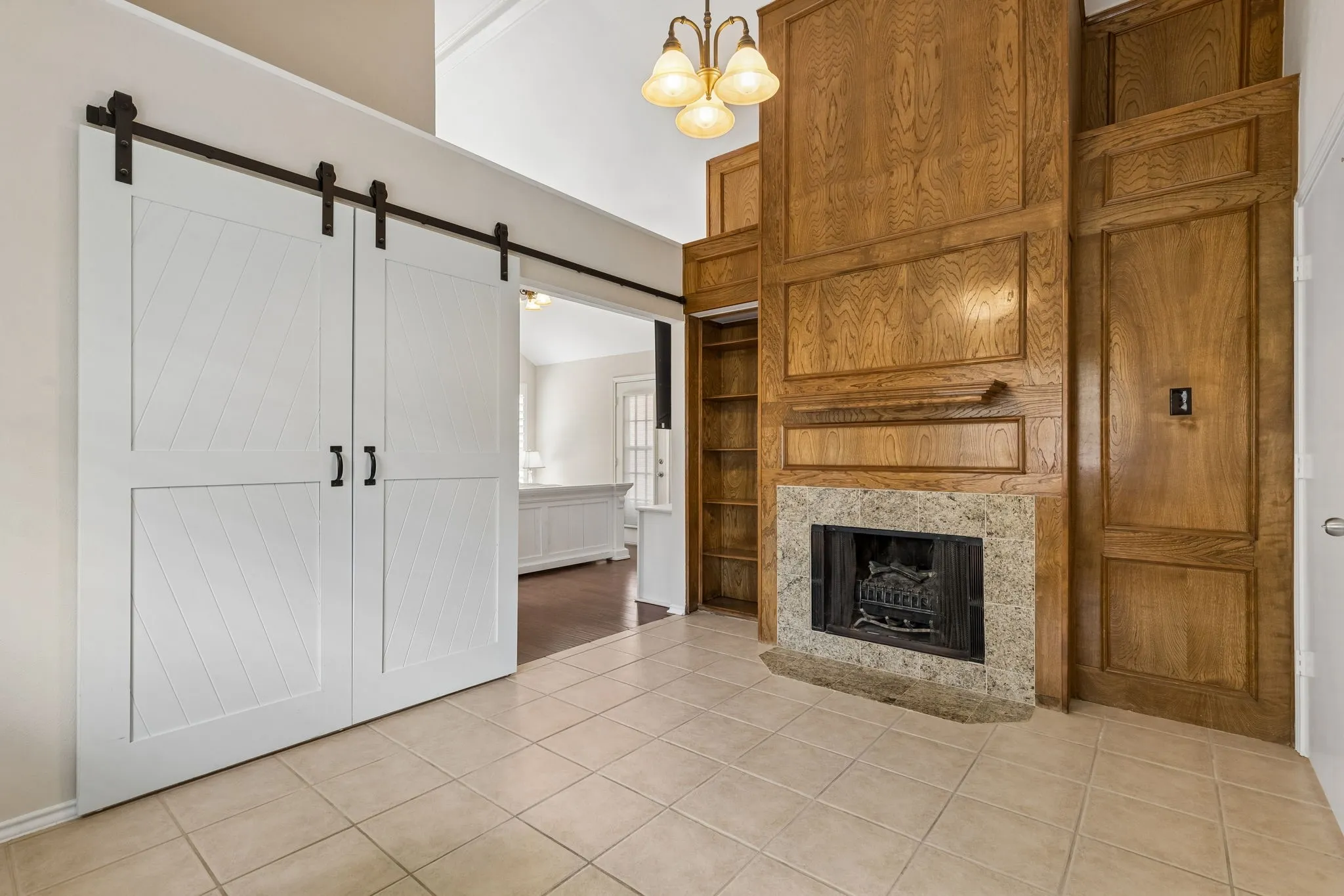 Second fireplace in bedroom 4 or study with built in shelves opens by barn doors to the primary bedroom.