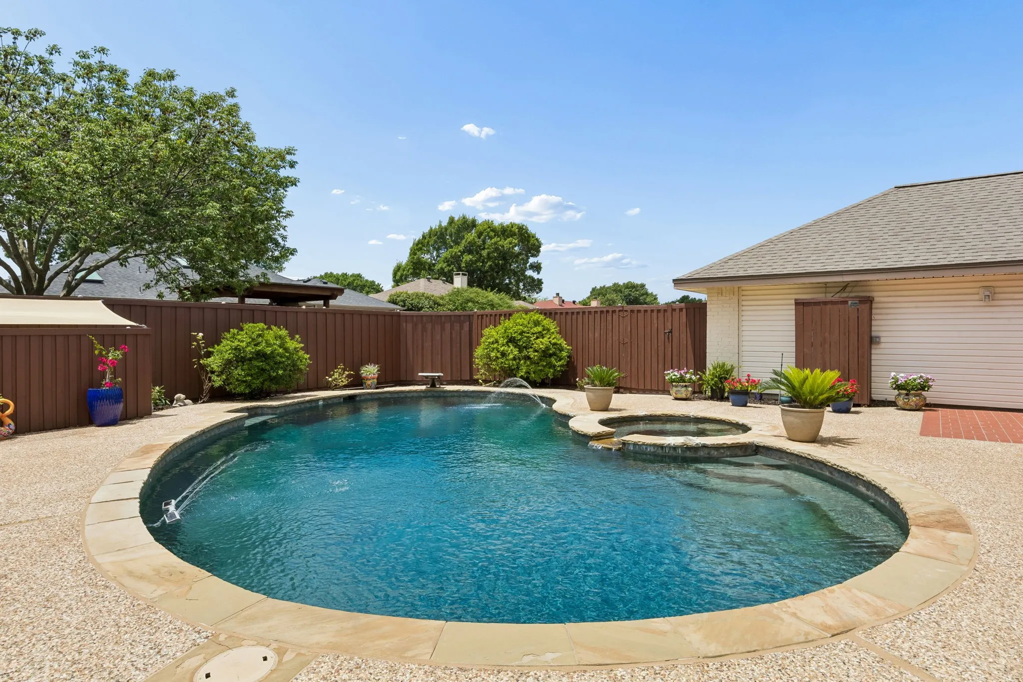 Another view of the pool and spa with two water fall solar pool fountains