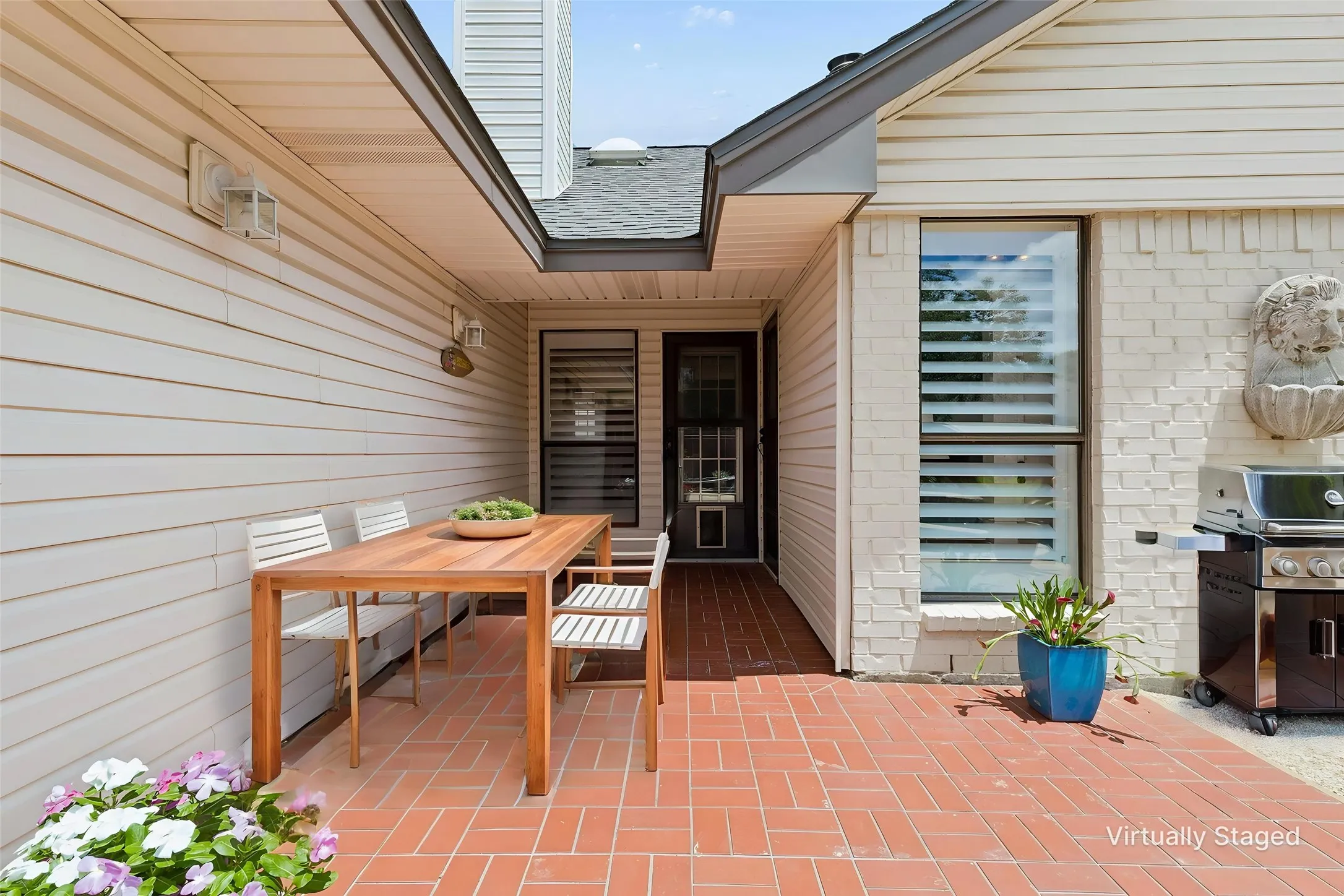 Back patio partially covered with brick look tile.