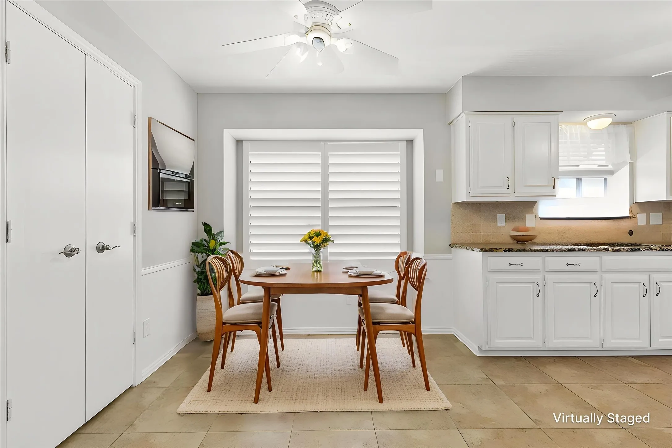 Breakfast Nook with tile flooring and plantation shutters.