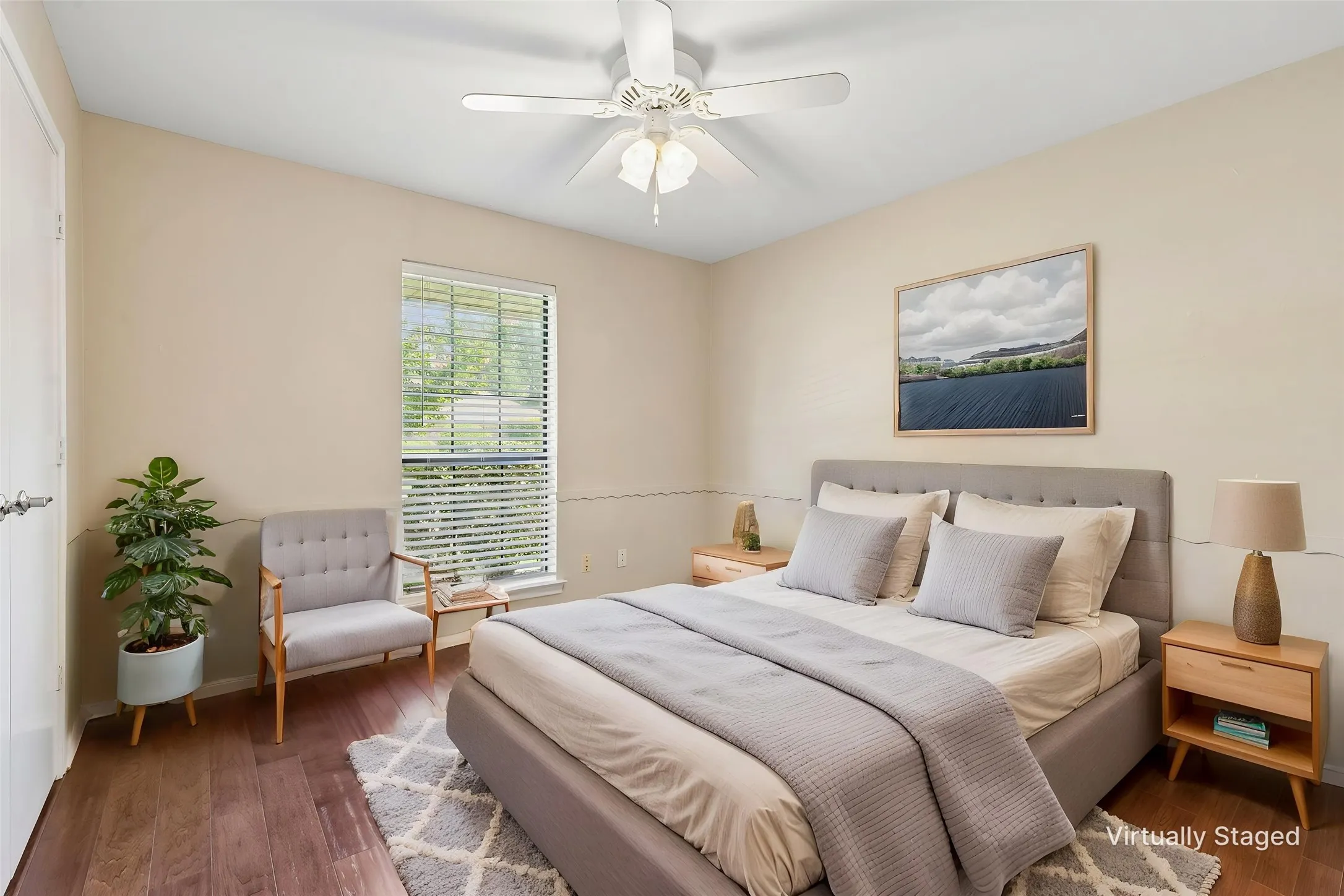 Bedroom 2 with hardwood flooring and ceiling fan.