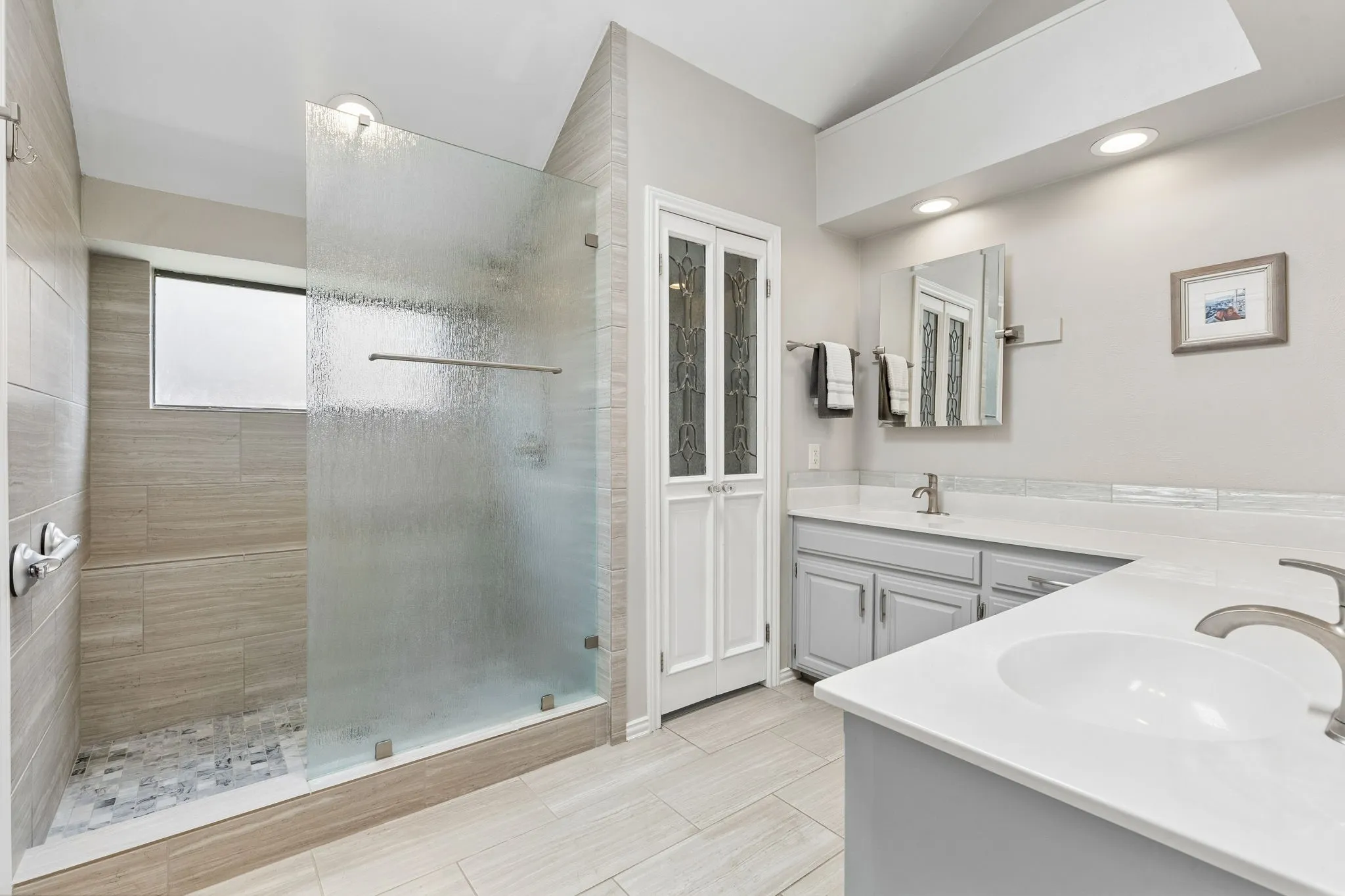 Remodeled primary bathroom with rain glass shower.  Replaced commode with Toto Bidet system through the lead glass inlayed vintage doors.  Both mirrors tilt.