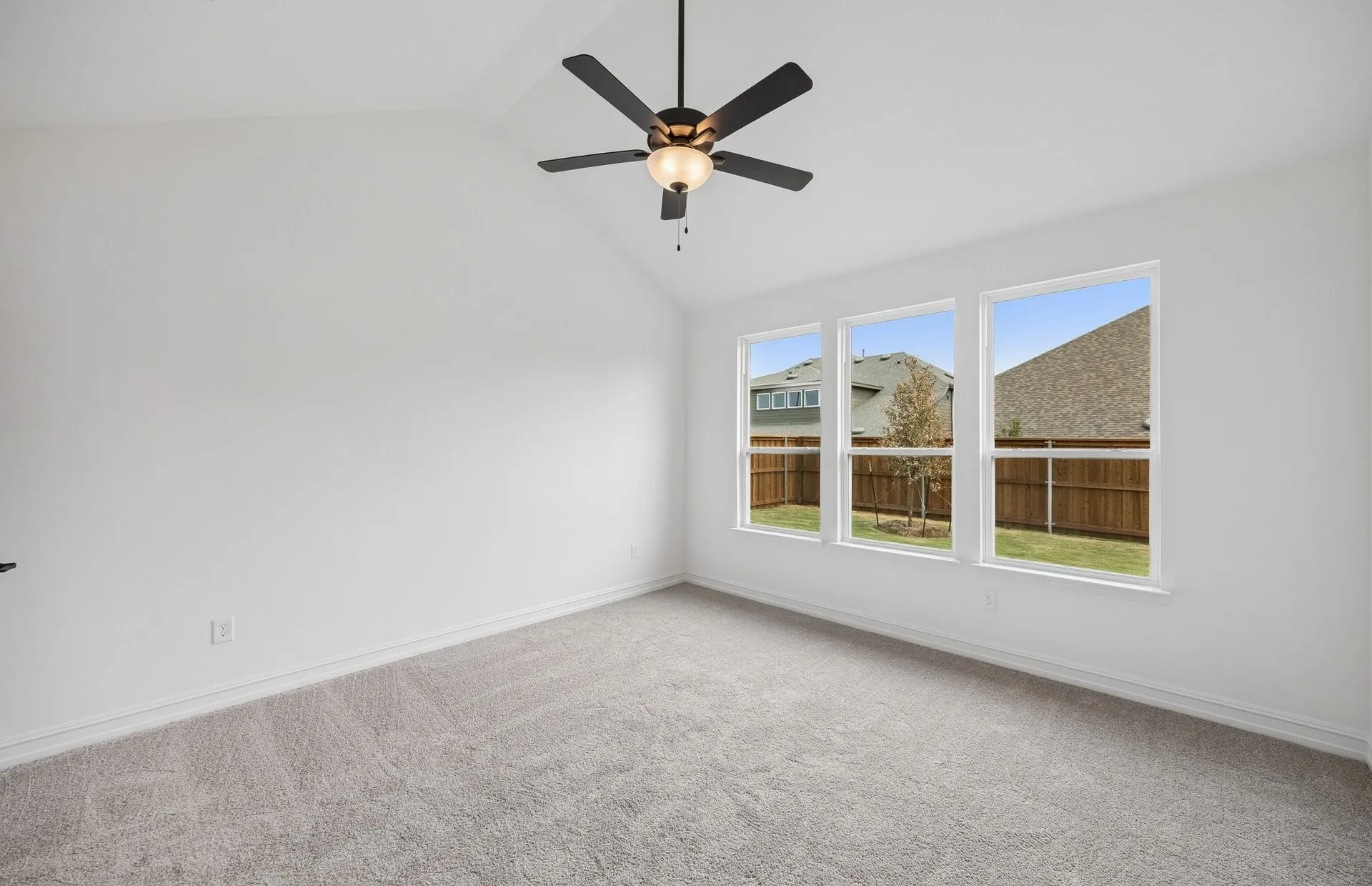 Primary bedroom with large windows