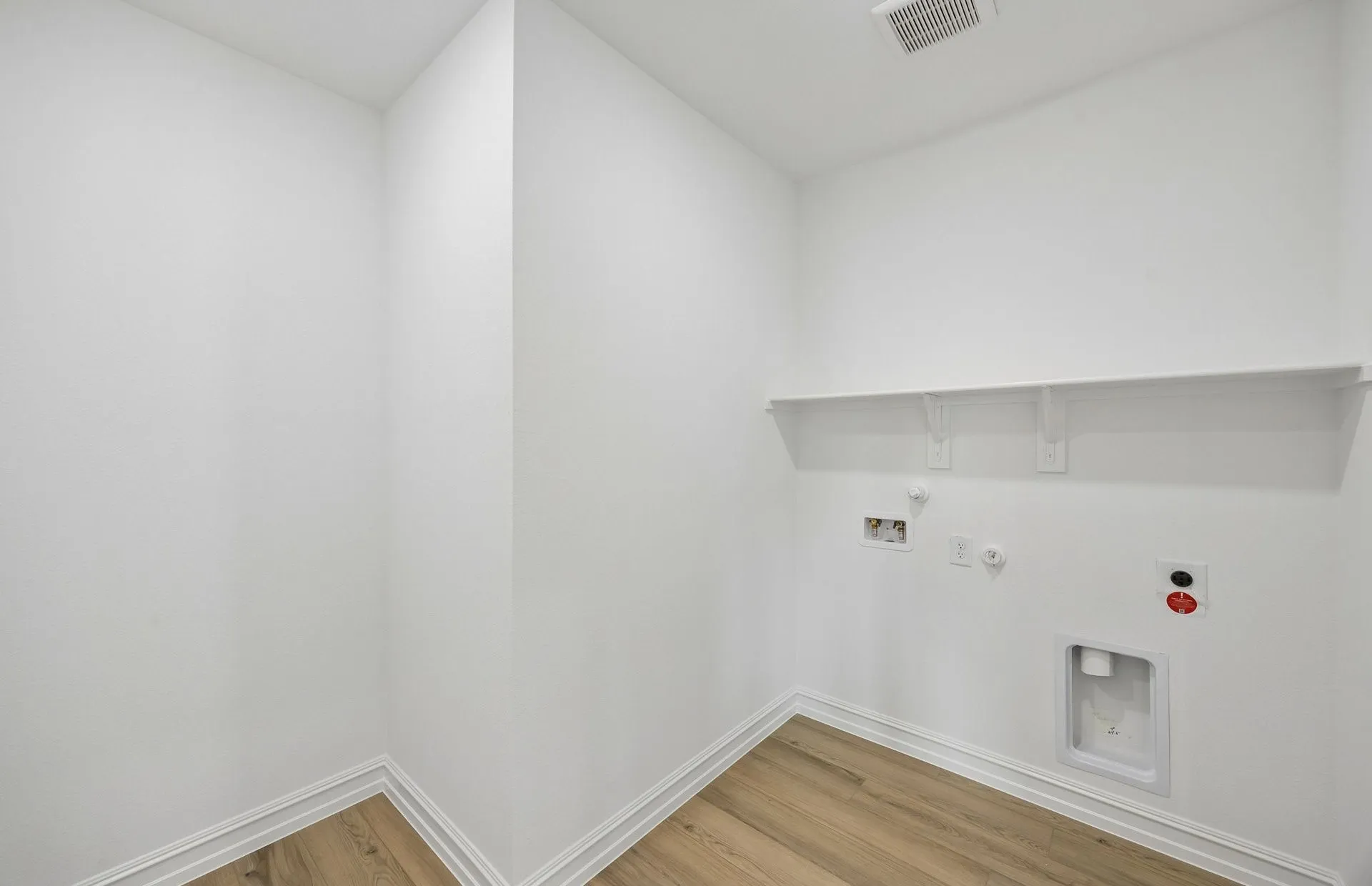 Laundry room with built-in shelving