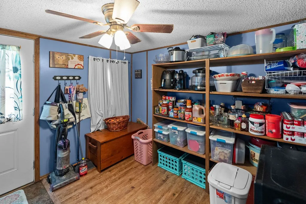Utility room just off kitchen has exit to the back door, lots of shelving, room for a freezer and overflow pantry.
