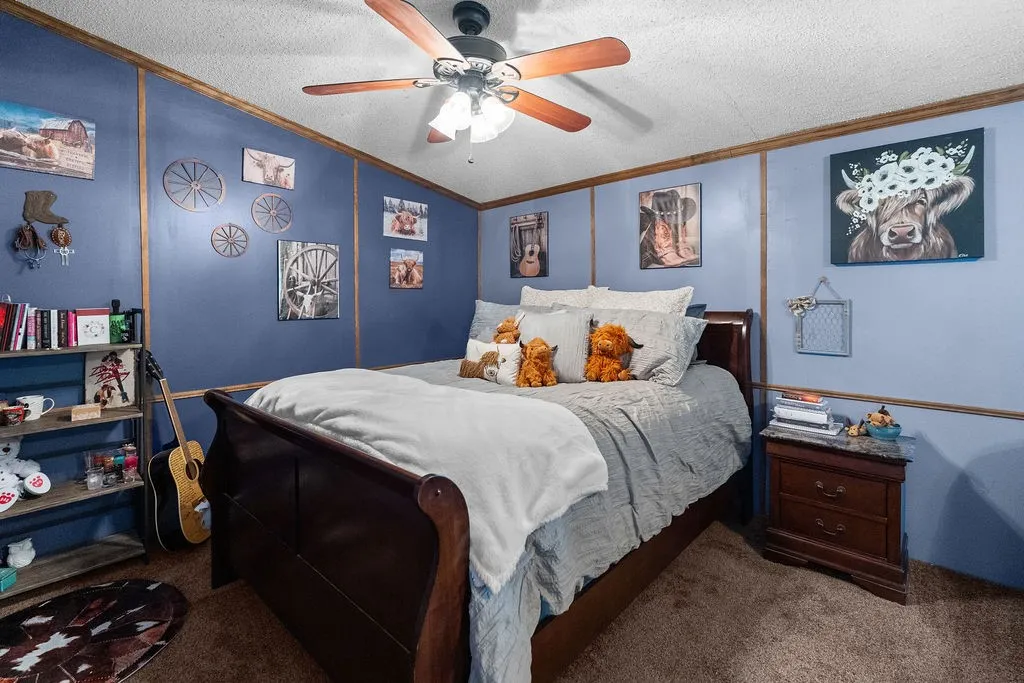 Primary bedroom is carpeted, with updated paint and molding details.