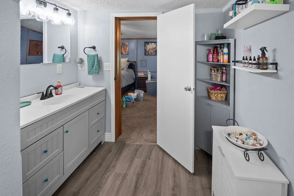 Primary bath has large vanity, lots of storage