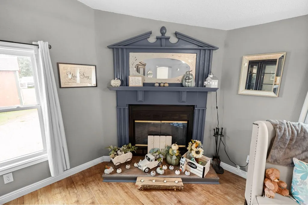 Wood-burning fireplace has updated hearth, glass doors