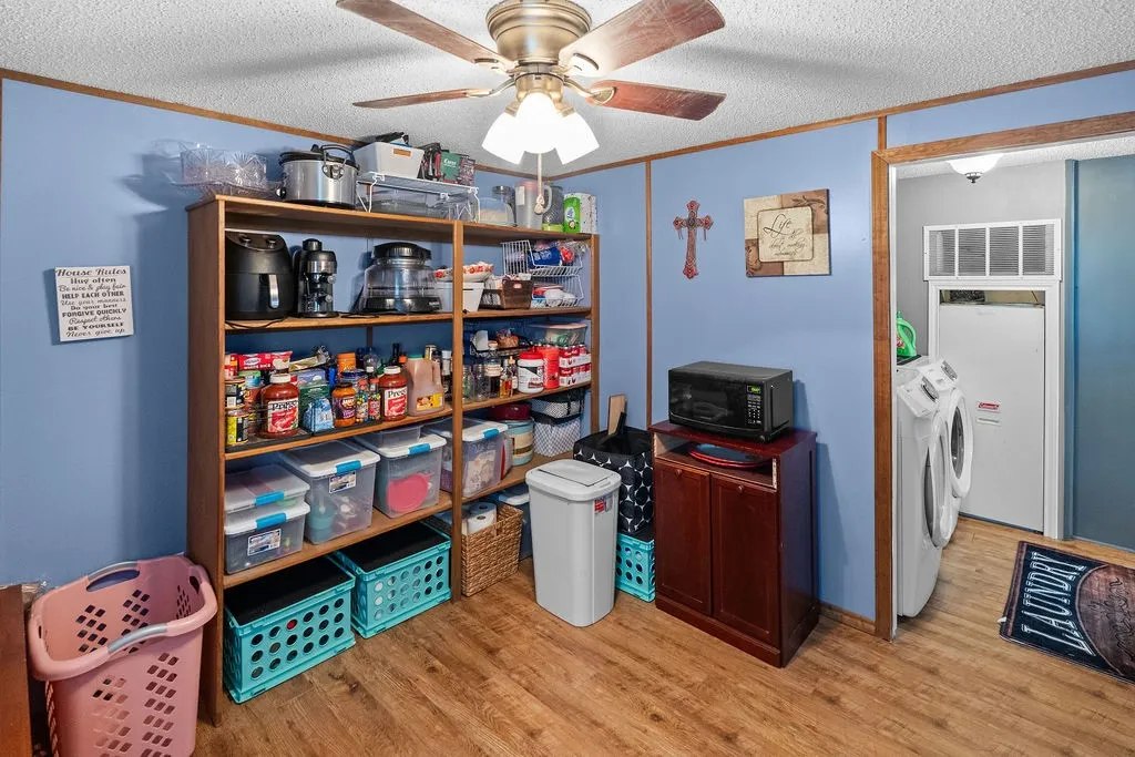 Utility room has full size laundry area, lots of storage space