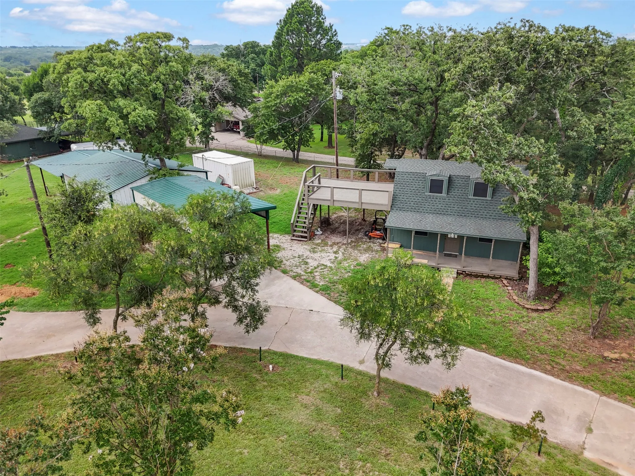 2 story Guest Home with a covered front porch and second story deck overlooking the scenery of property.