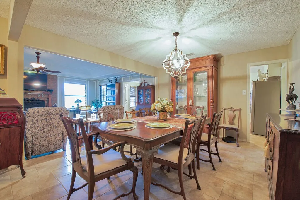 Dining area with tile flooring and a decorative chandelier