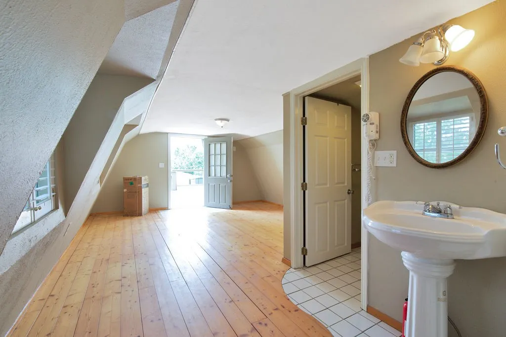 Second story of guest home, featuring a ceiling medallion with crown molding, and two windows.
