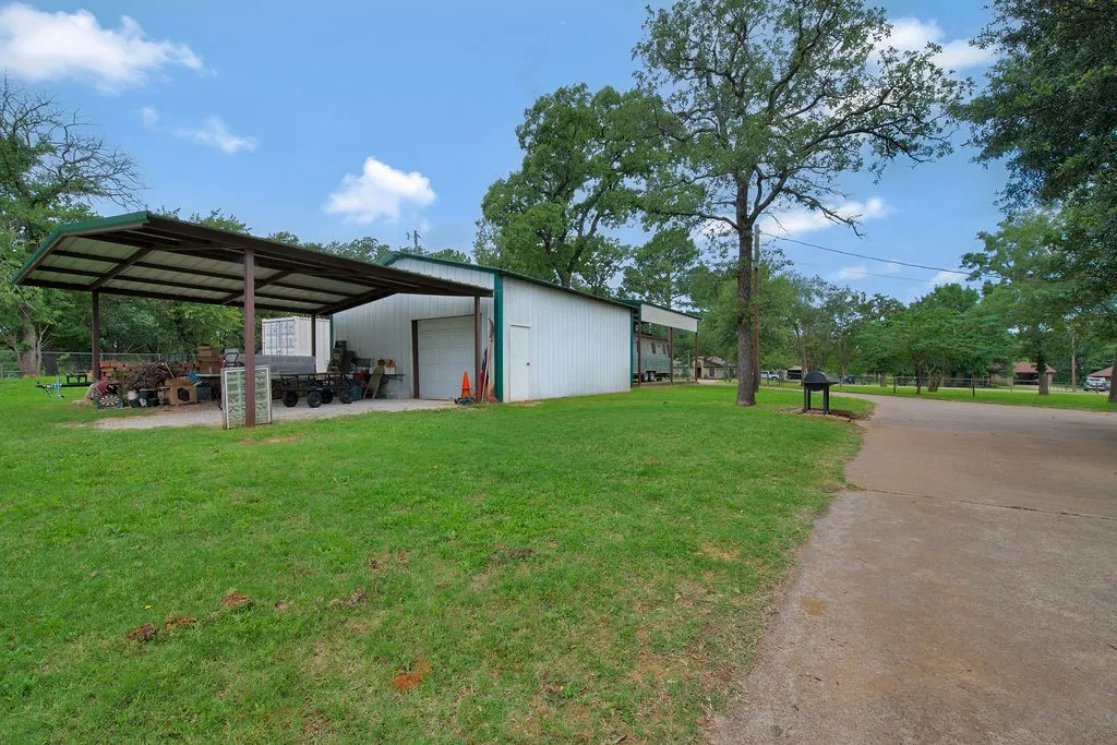 Shop with Covered parking on both sides.  One Side Offers RV parking.