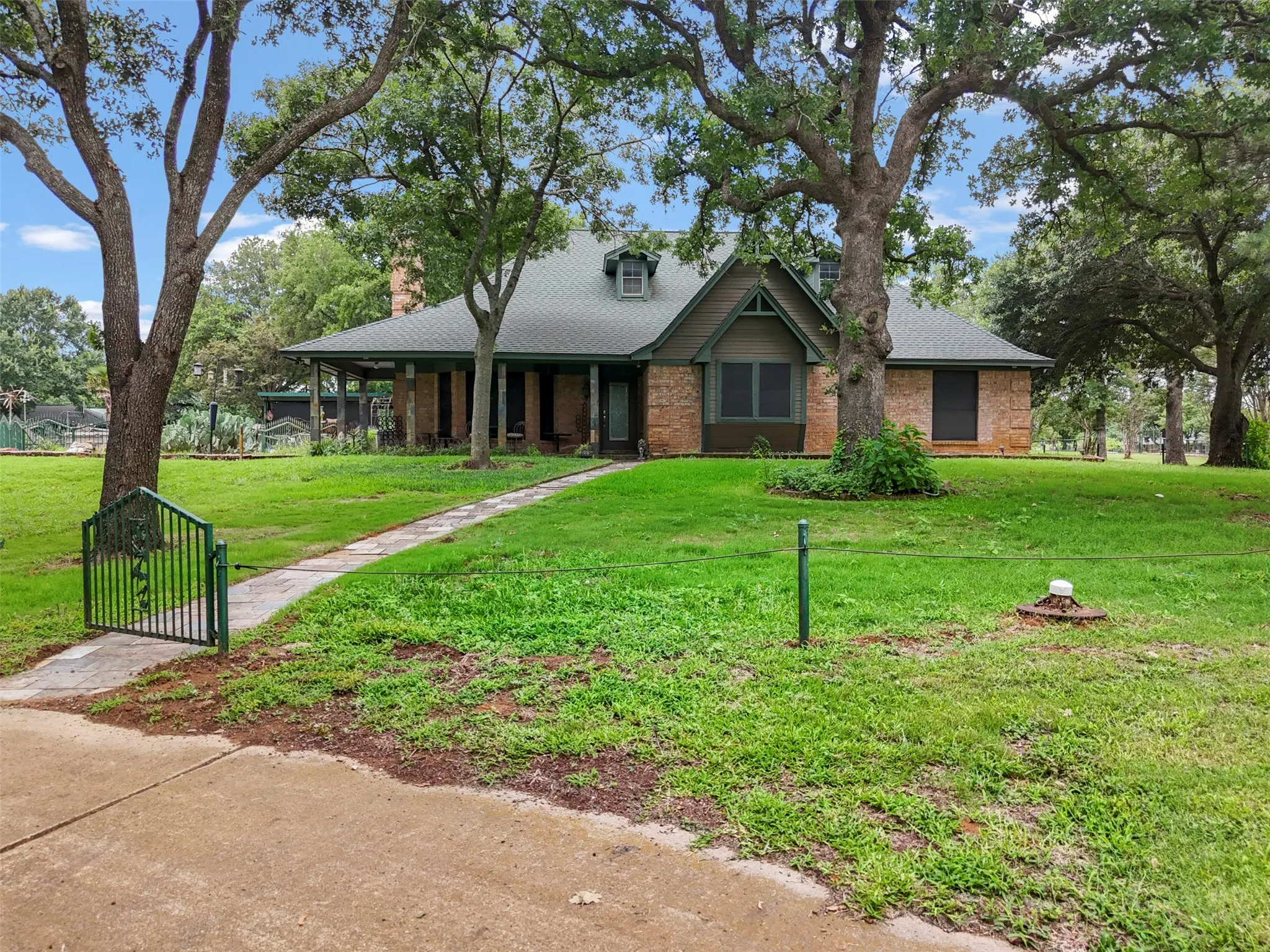 Brick exterior residence with a full-width covered porch and gabled dormer.  This home offers 3 wells.