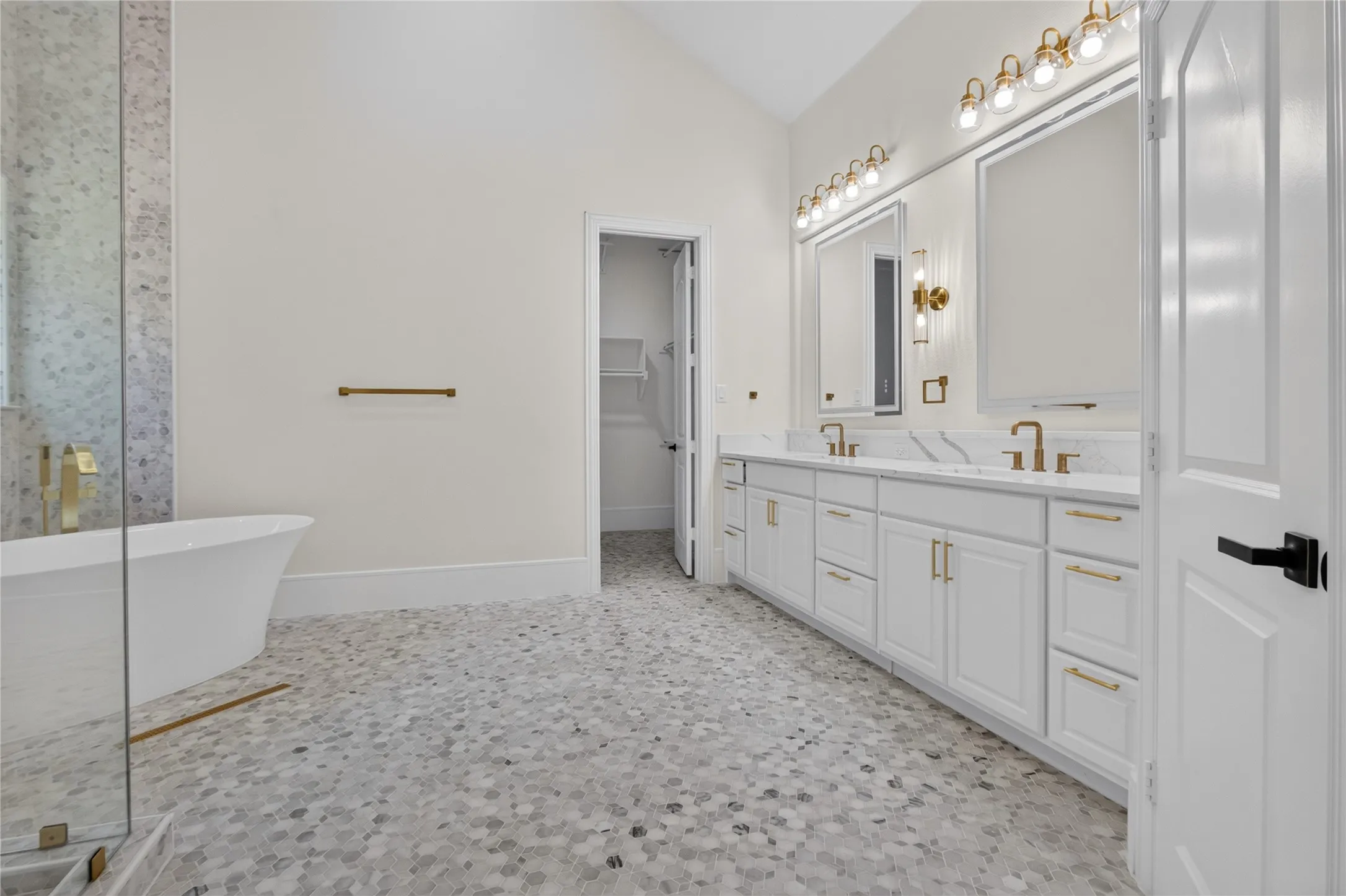 Dual vanity with white cabinetry, gold-finish hardware, and quartz countertops