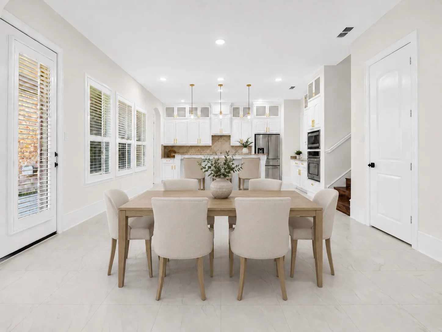 Open-concept dining and kitchen space featuring l
